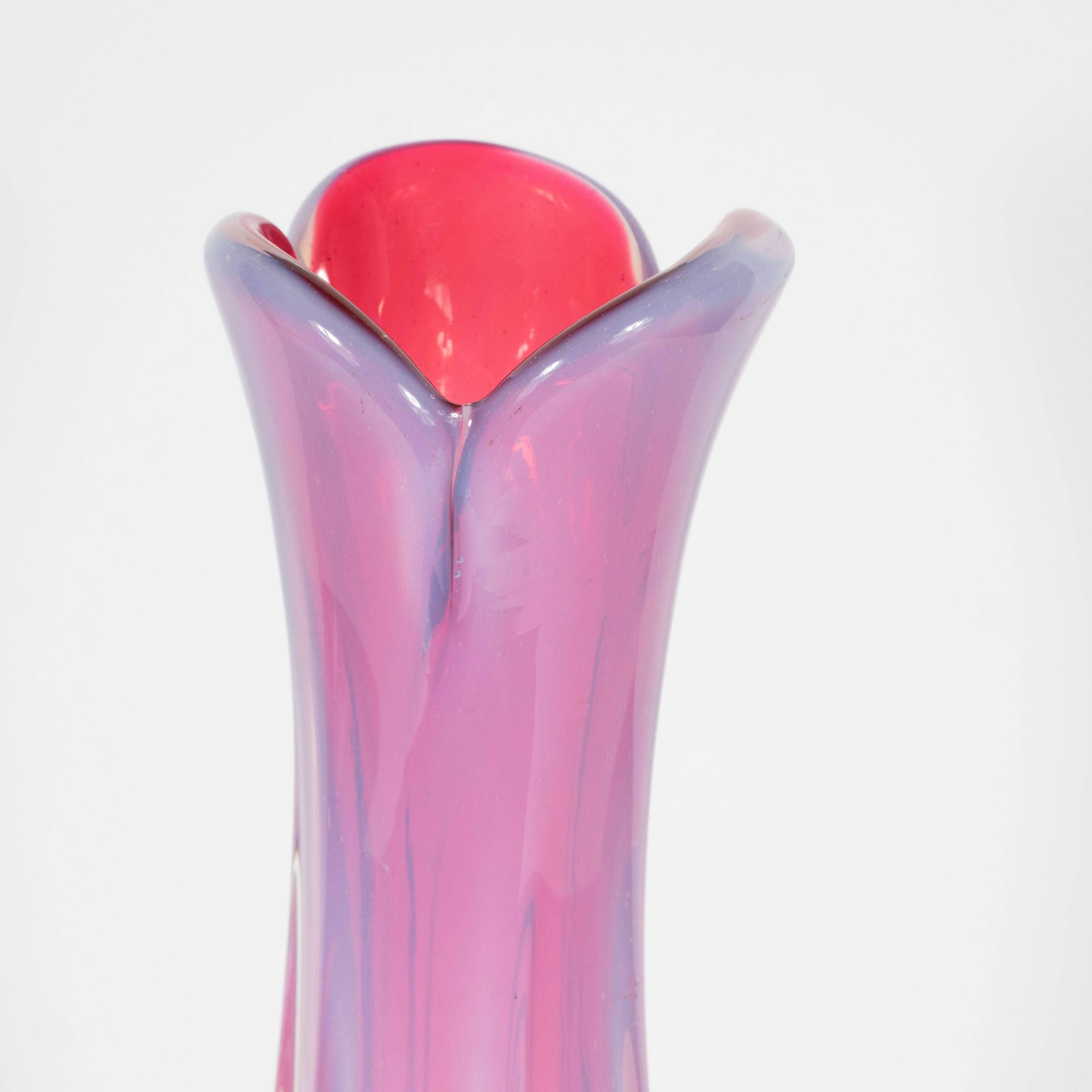 This sophisticated Mid-Century vase features six translucent fins protruding from the gently tapered and elongated body. The vase was handblown, circa 1950, in Murano- the legendary Venetian island renowned for centuries for its glass production.