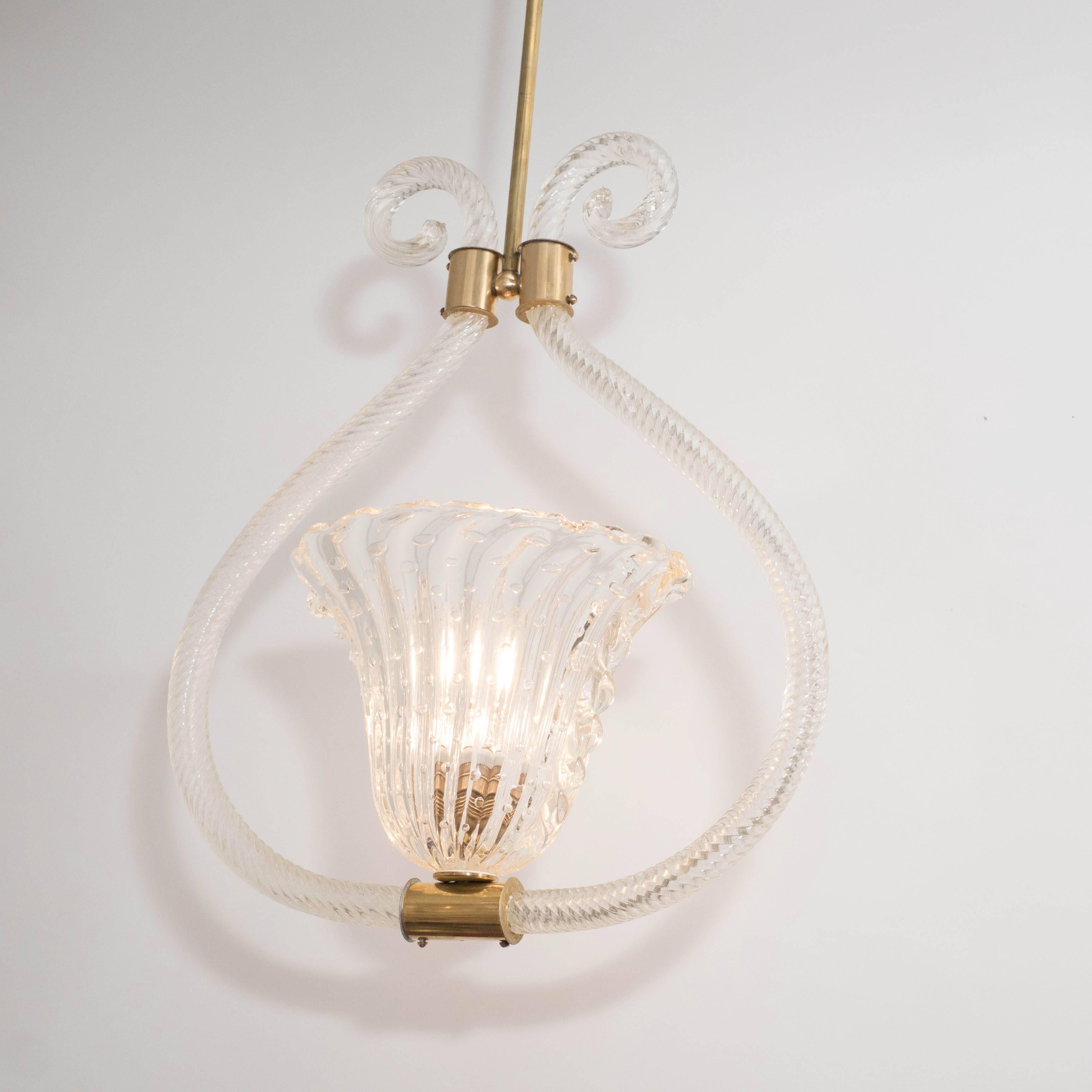 A Barovier e Toso pendant in handblown 'Bullicante' Murano glass and polished brass. A ribbed and controlled-bubble glass up-light shade supports a standard-size socket. A pair of ribbed tubular glass supports featuring scroll end-detailing are