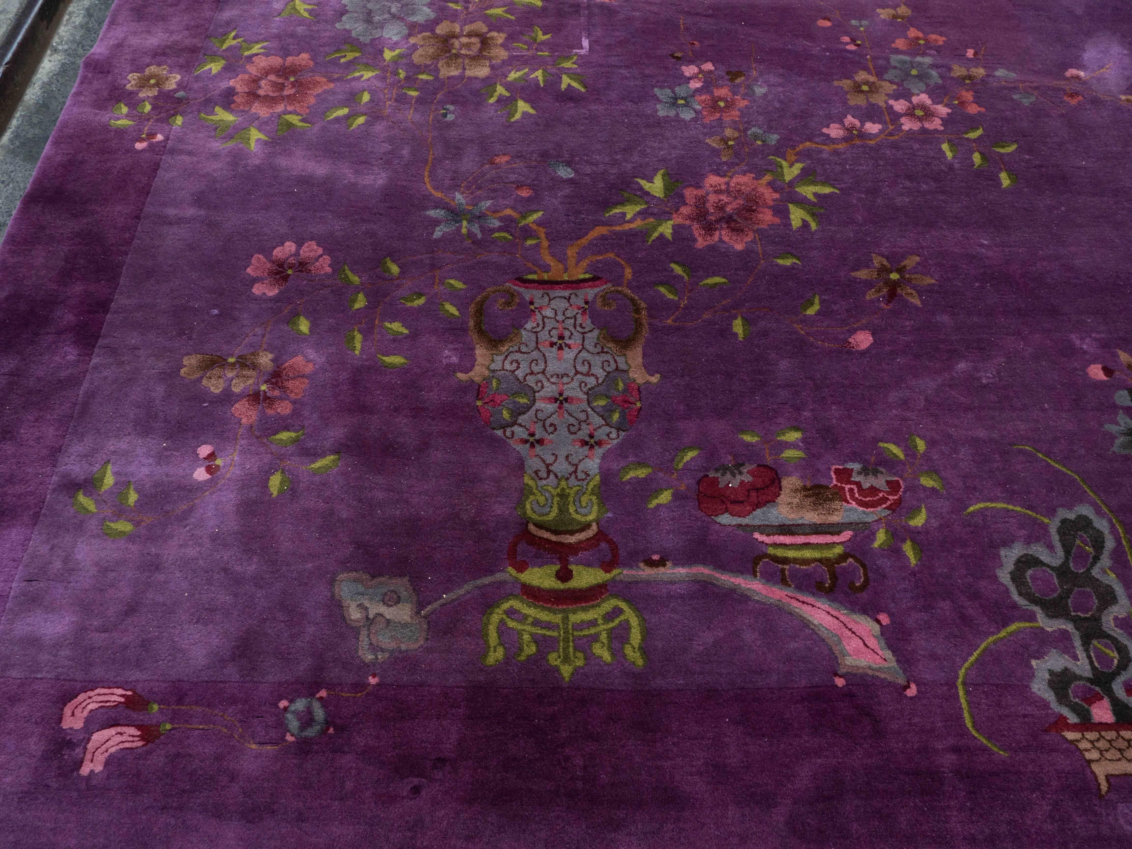 Exotic Chinese Art Deco rug in shades of lilac, purple and mauve wool, circa 1925. 
A very decorative good sized rug delicately decorated with exotic flower patterns and traditional Chinese vases and Bonsai planter a warm and appealing rug to