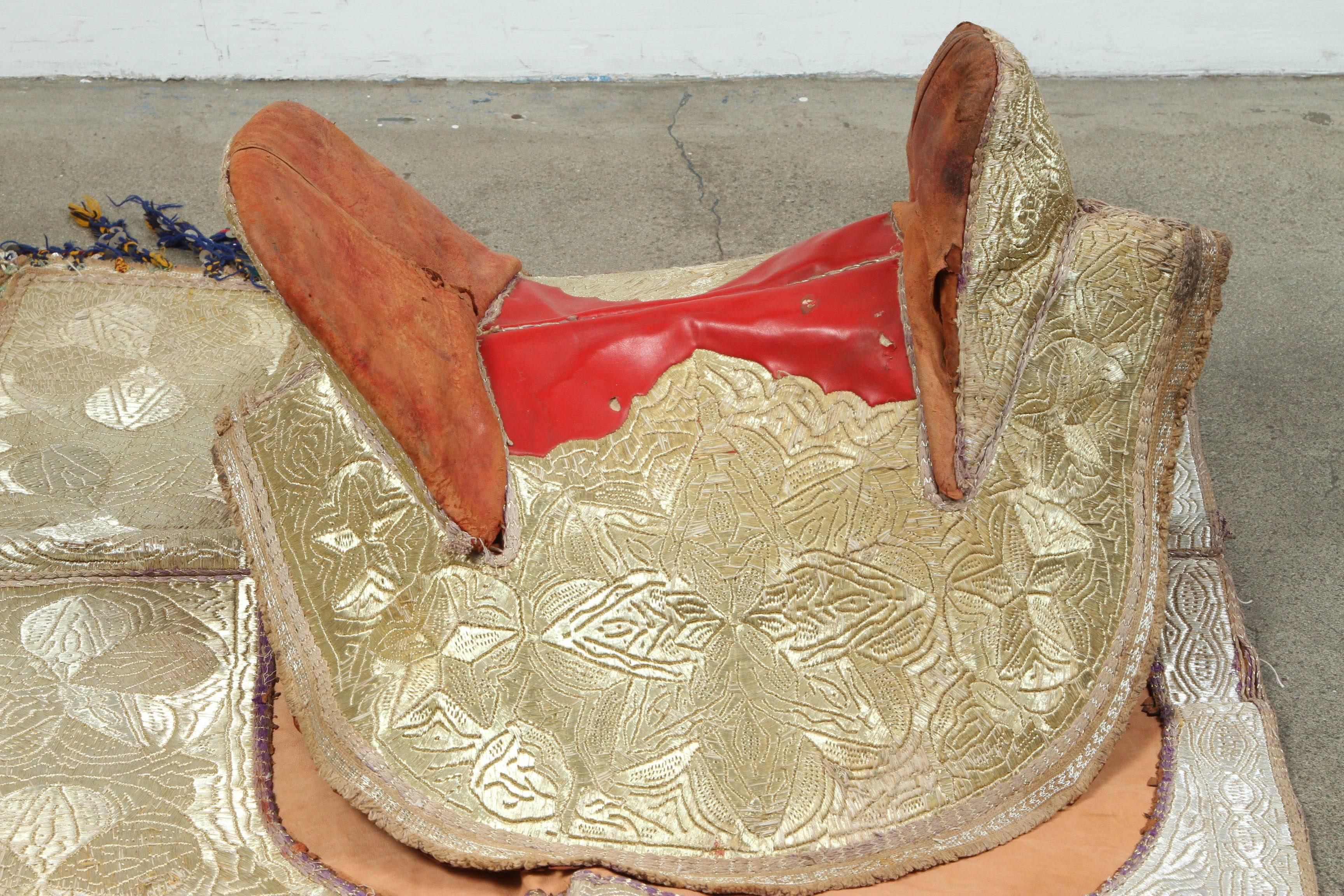 Handcrafted Moroccan horse saddle set made for a ceremonial Festival and shows, the entire ensemble elaborately embroidered overall in gold threads, comprising of a saddle cover, saddle pad and wooden raw saddle, the central section of the saddle