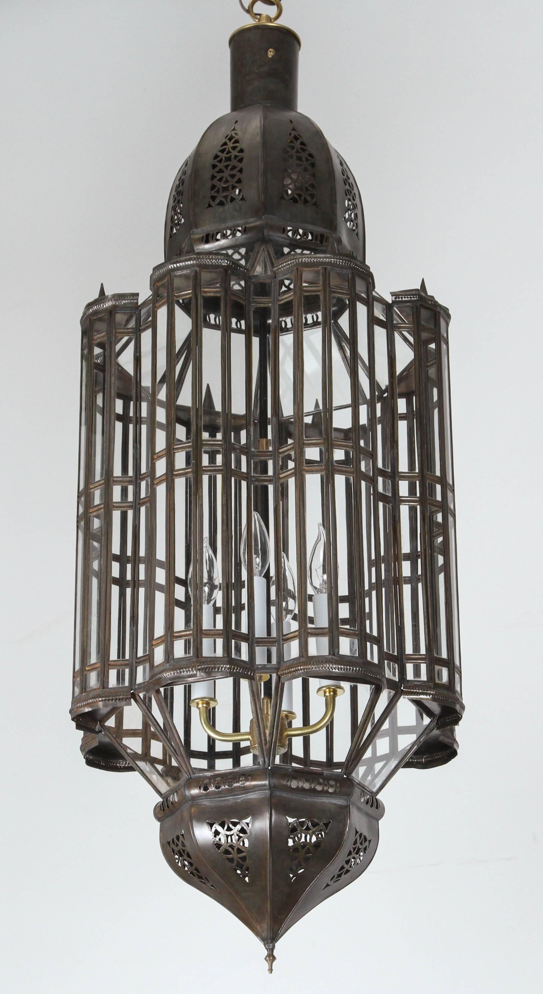 Large-scale Moroccan, Moorish style chandelier.
Metal and clear glass Moroccan light fixture, wired with a cluster of three lights.
Comes with chains and canopy ready to install, chains could be adjusted to your needs.
Glass body height: 44 in.