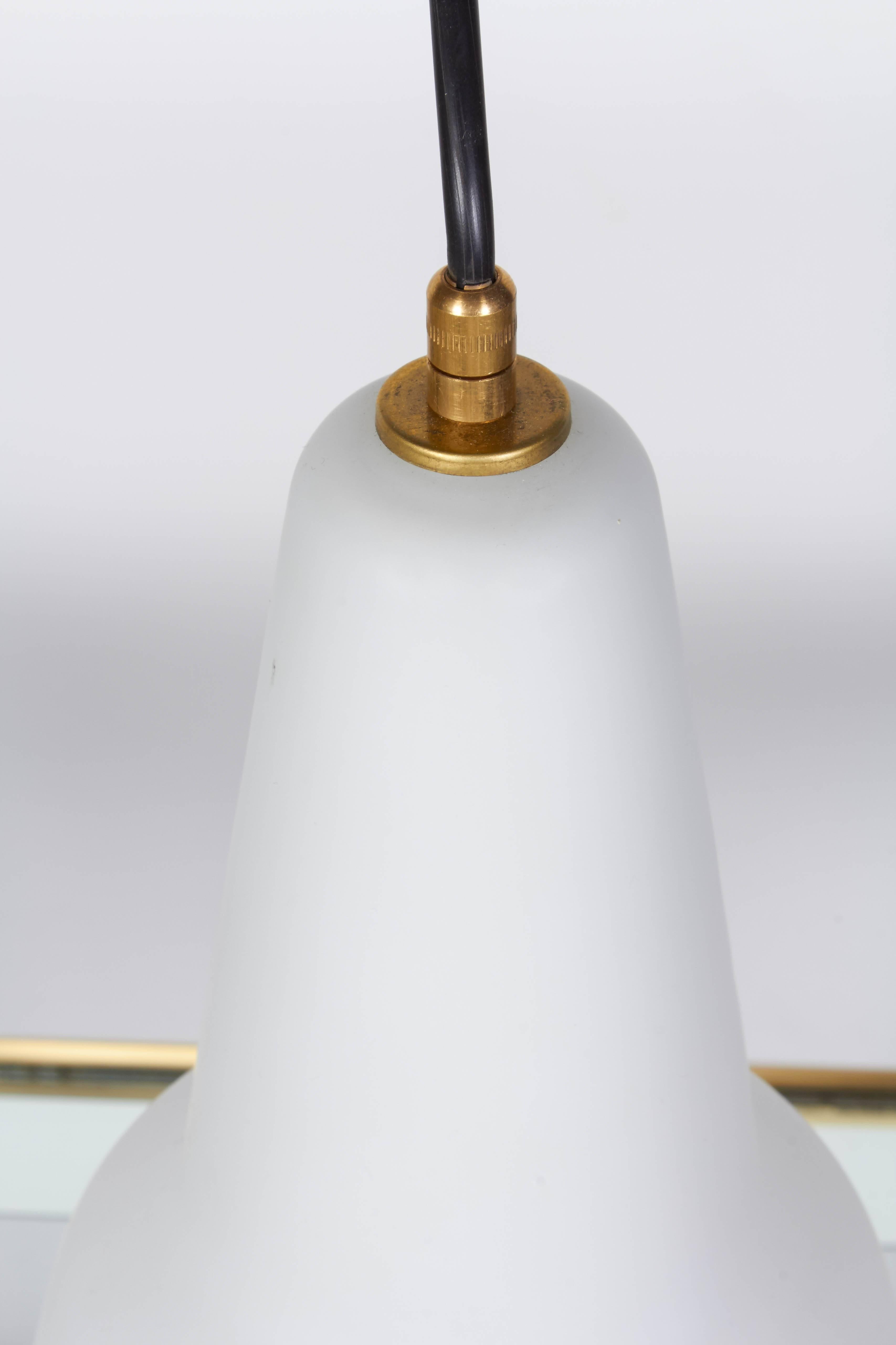 One of a group of Italian handblown pendant light, circa 1950. Glass shade is layered with a clear satin finished over white in a tear drop shape. Holds one standard light bulb. Measures: Shade is 8.5