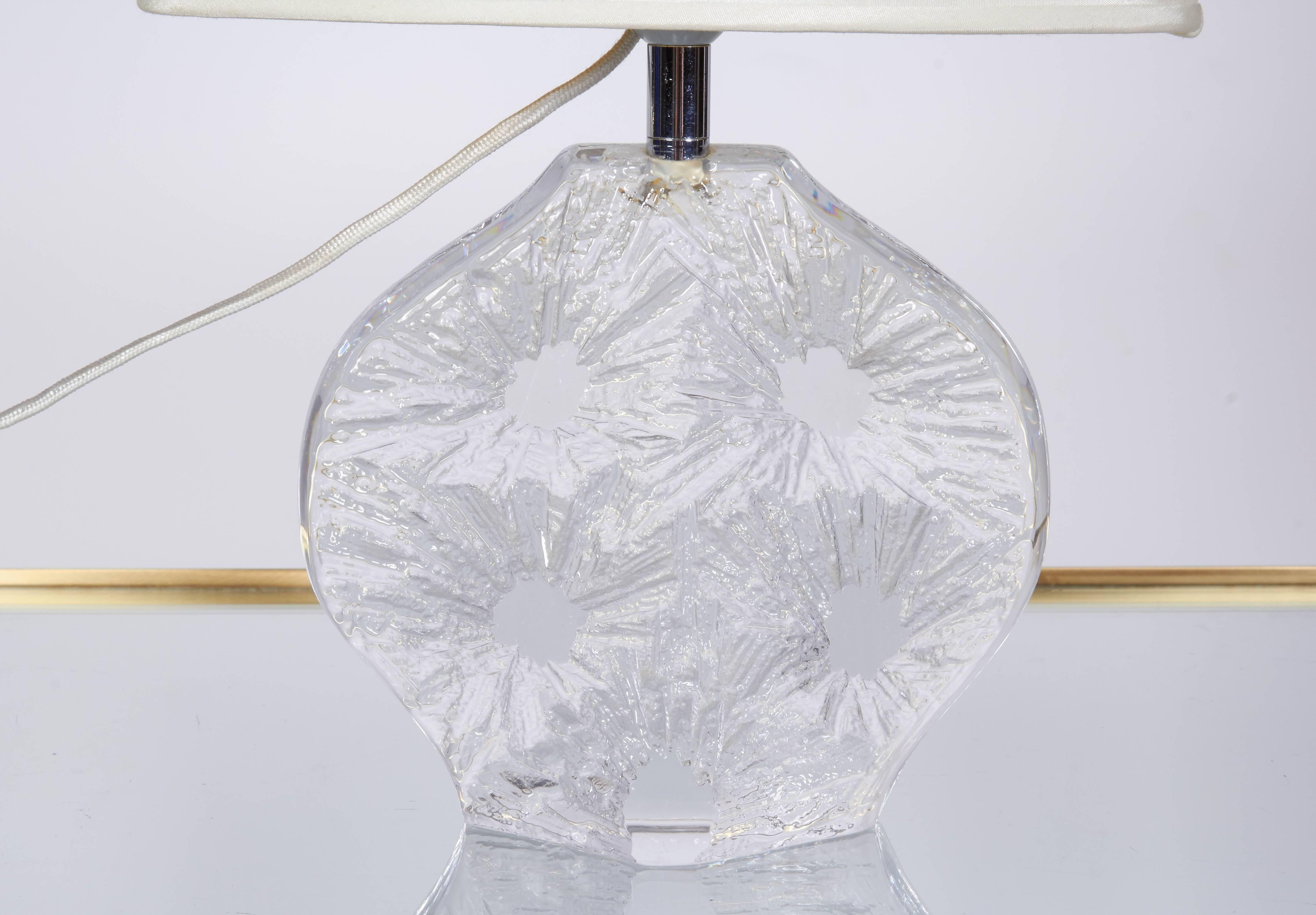 A lovely abstract design in crystal by French glass house Daum, circa 1970. The base is smoothly polished glass on one side and carved in a three dimensional abstract design on the reverse side. Base measures 6.75