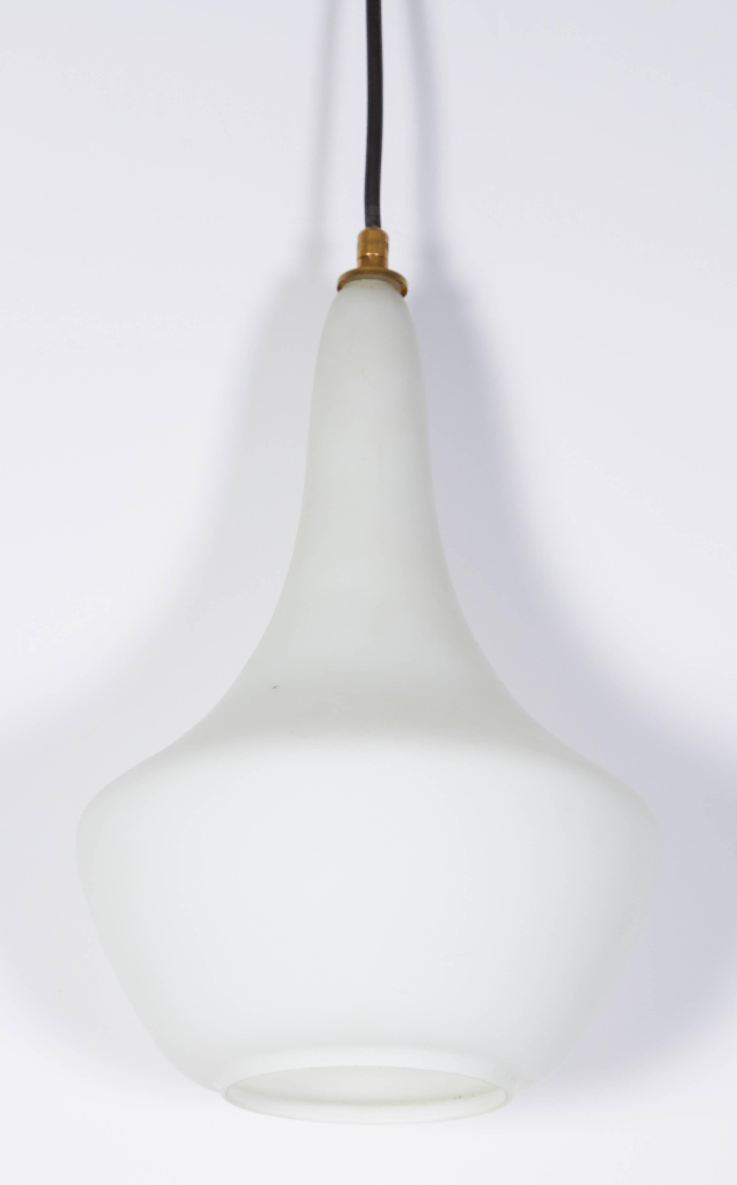 One of a group of Italian handblown pendant light, circa 1950. Glass shade is layered with a clear satin finished over white in a tear drop shape. Holds one standard light bulb. Shade is 8