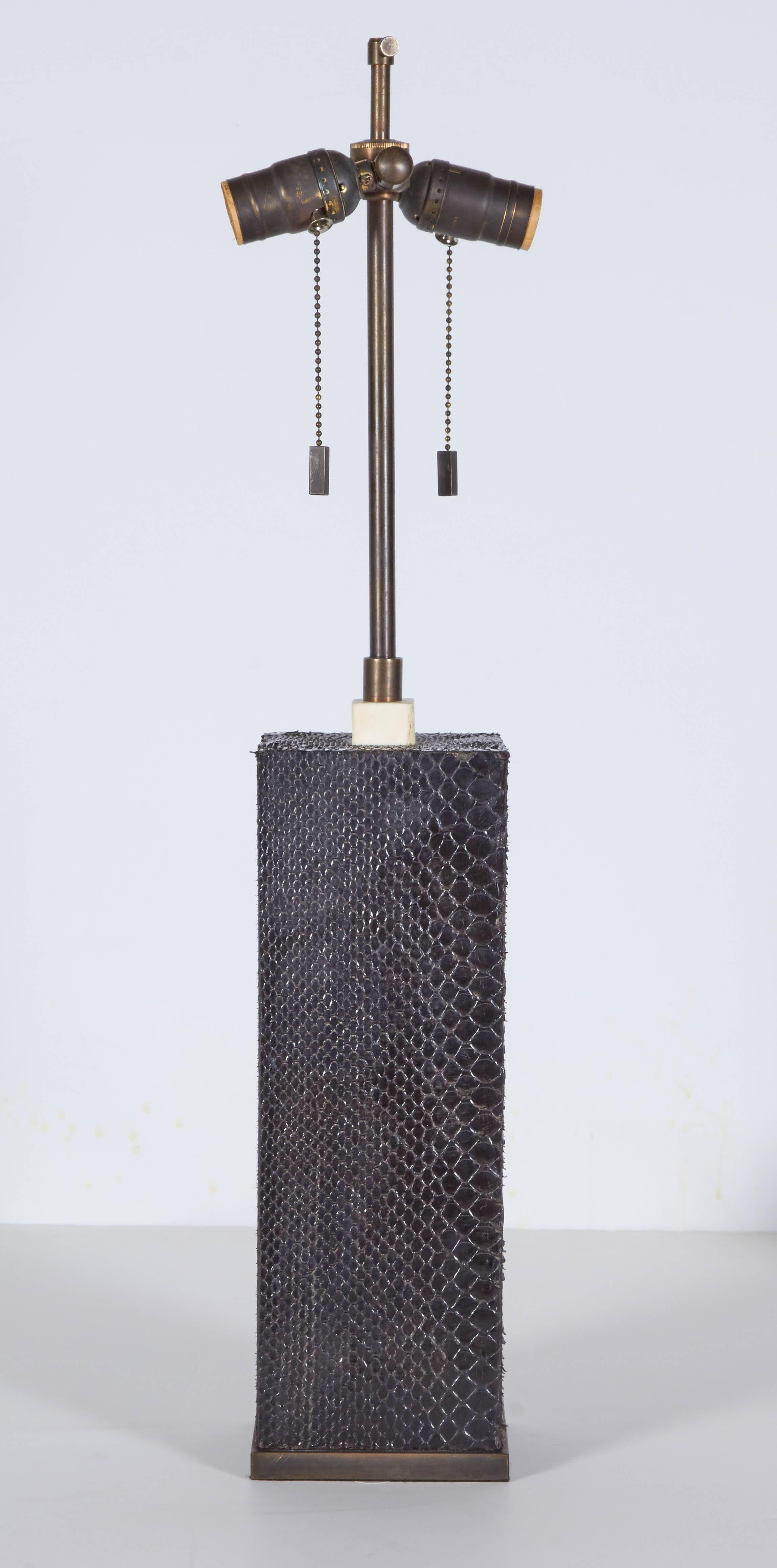 Pair of very stylish lamps finished in a chic black snakeskin. Please contact for location. 