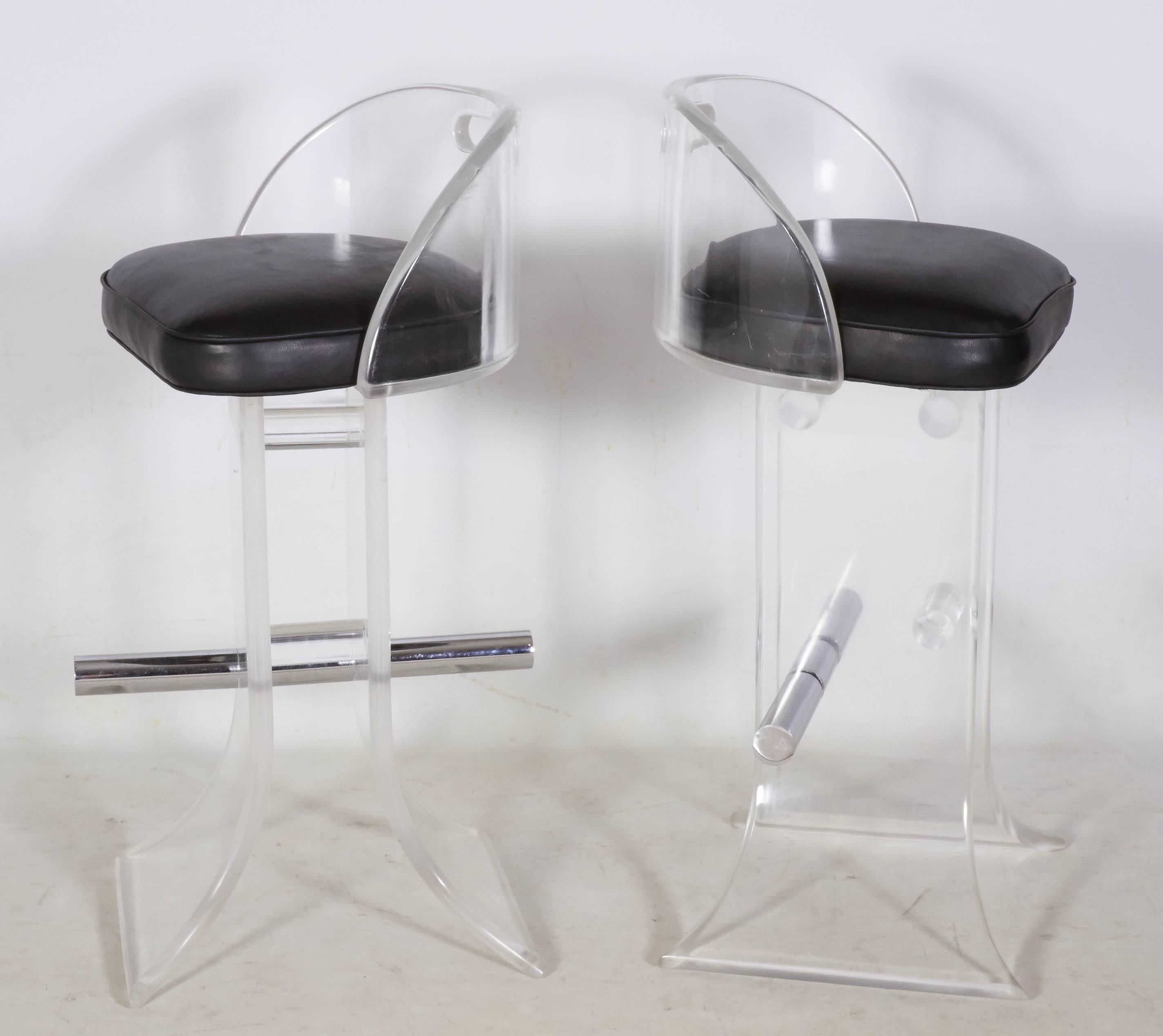 Glamorous pair of curvaceous Lucite bar stools by master Lucite designer Charles Hollis Jones. The stools are substantial with very thick Lucite and are beautifully accented with polished chrome and black lambskin seats. A second pair is available.