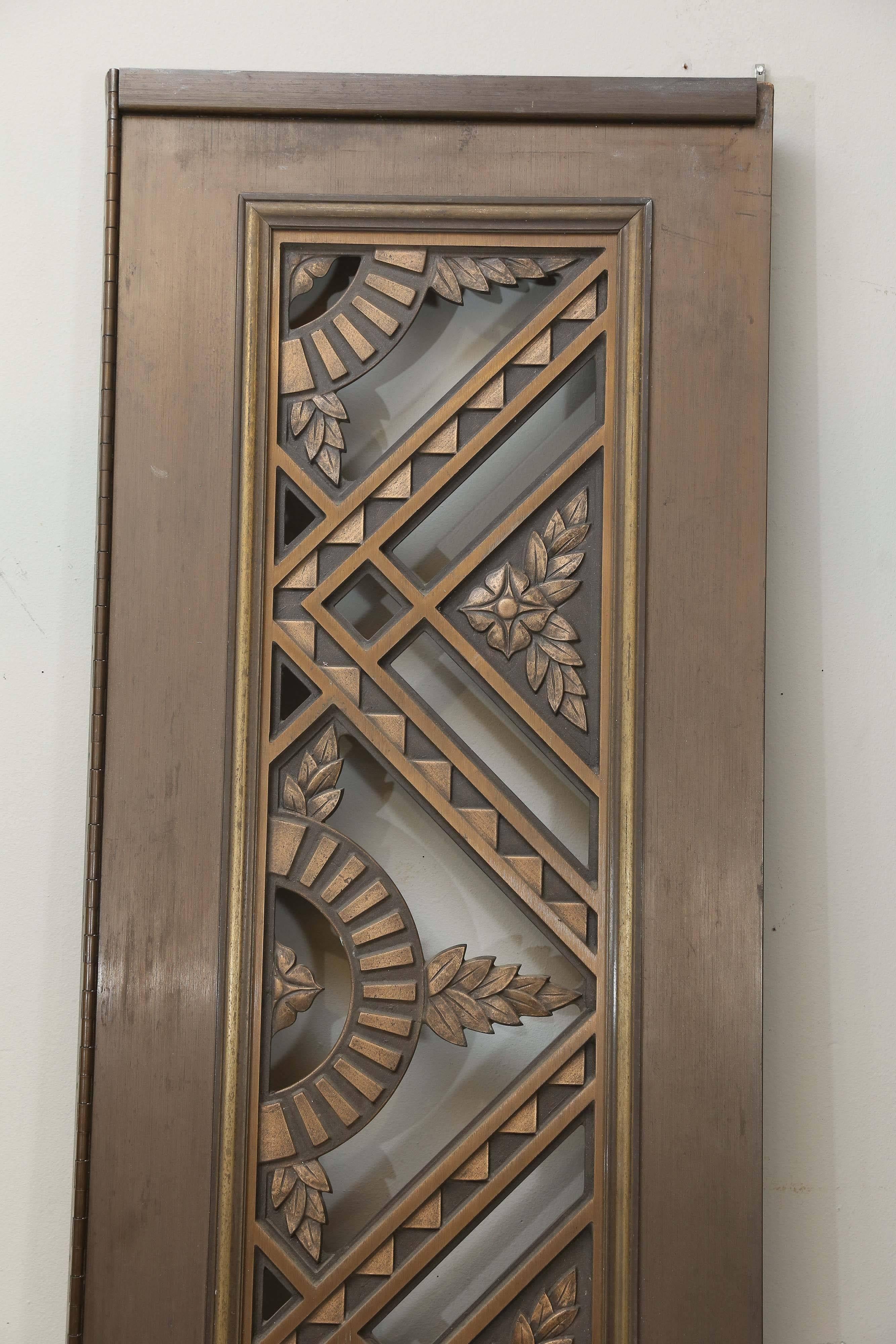 Skillfully crafted, artist cast, bronze and copper doors, 

 French, 1925-1930s.
 Condition is very good. 
 Measures: 81” H x 19” W.
                   