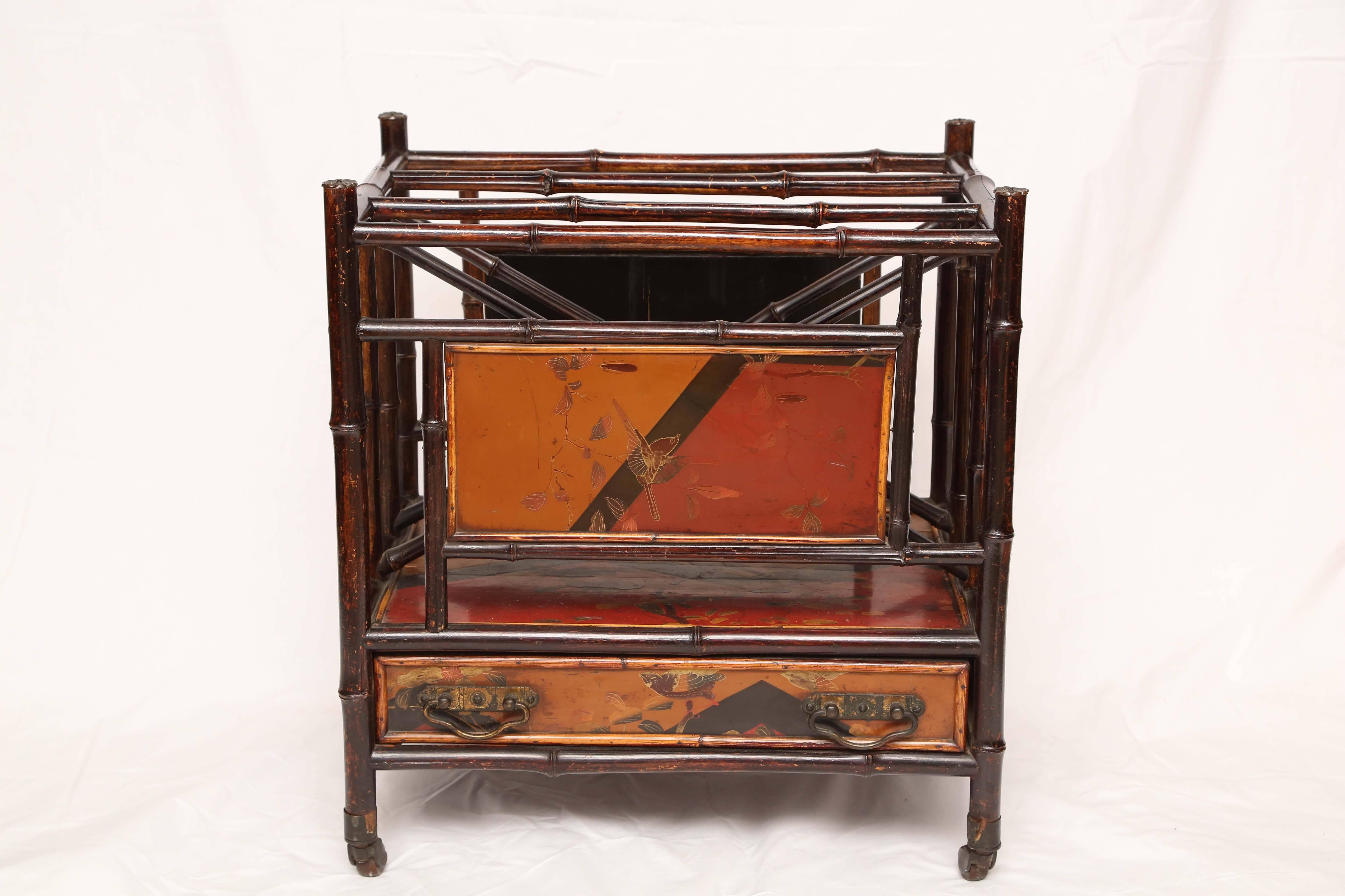 19th century English bamboo Canterbury magazine rack on wheels with one drawer and lacquer japanning all-over.