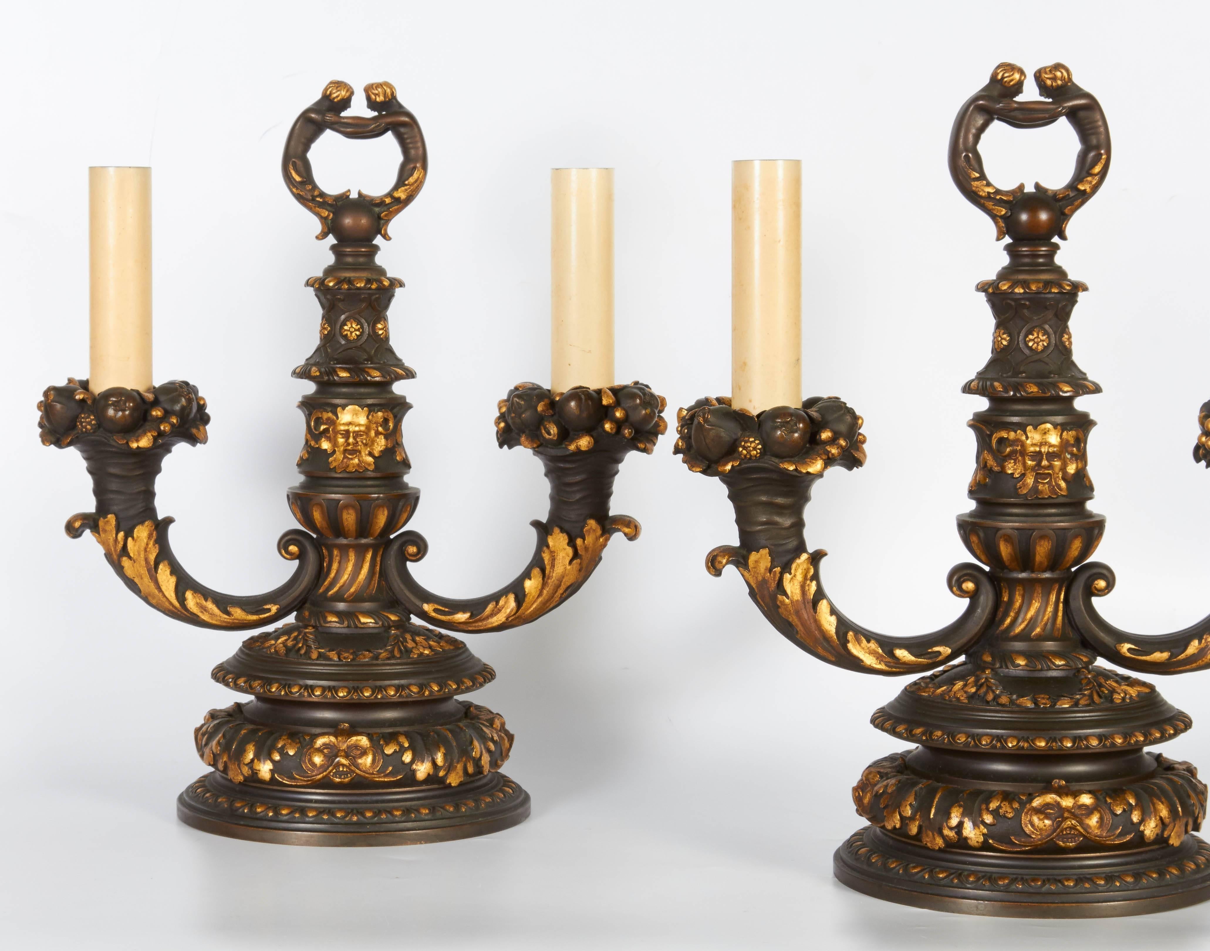 A fine pair of American parcel-gilt and patinated bronze, twin light candelabras/ table lamps
attributed to Edward F. Caldwell & Co, New York, first quarter of the 20th century.
Each with loads of overwhelming garlands of flowers and fruits