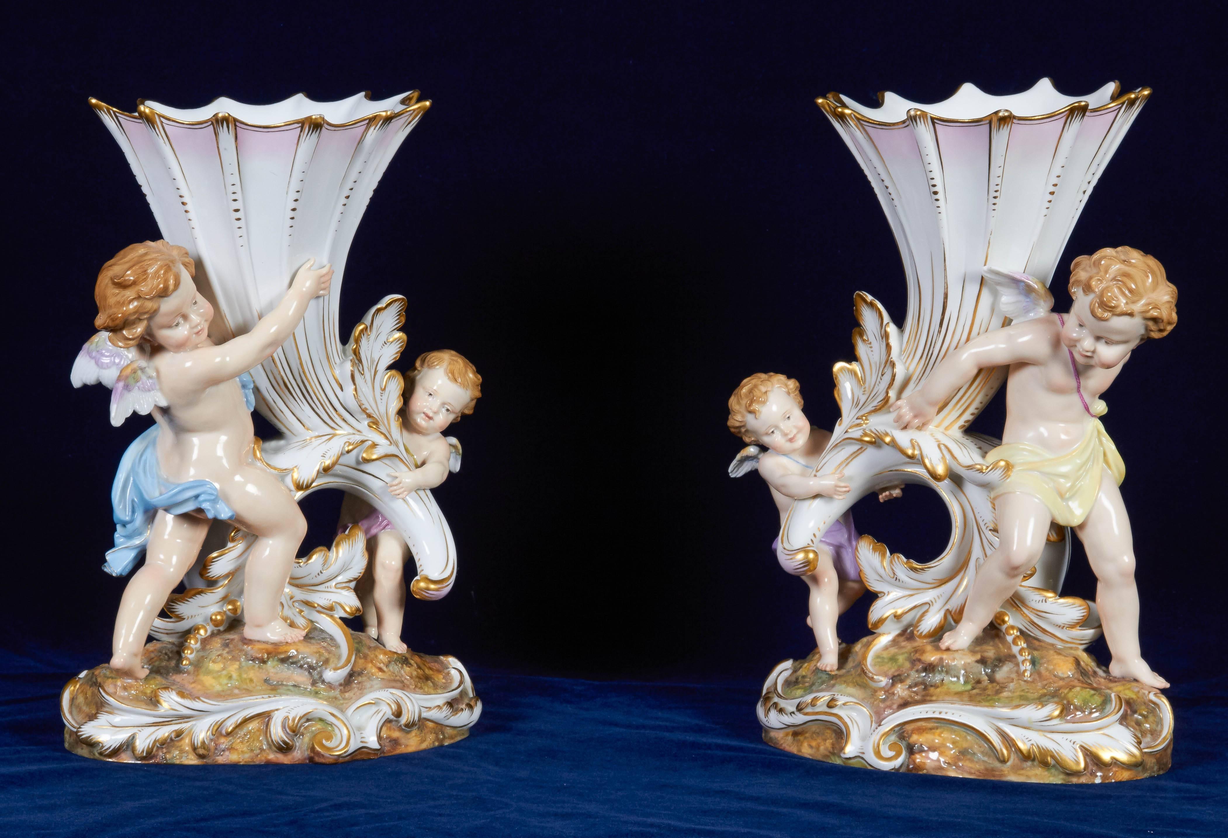 A fine and quite unusual pair of large antique Meissen porcelain groupings, with each cornucopia carried by two Meissen children / cupids, all in different positions. Finely decorated with the best enamel colors of Meissen, in the second half of the