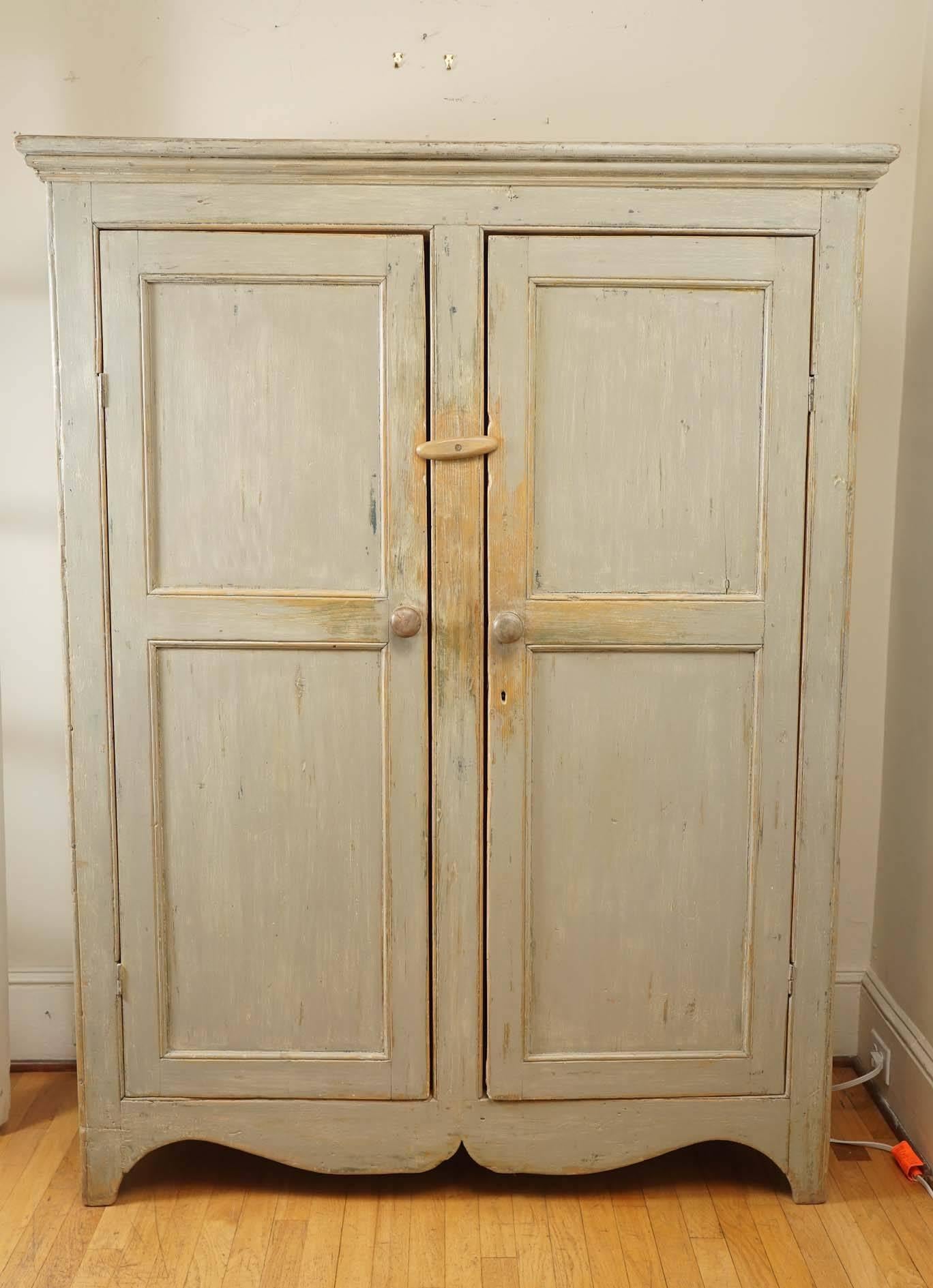 This gorgeous painted armoire is a very soft light green color and has a beautiful scalloped bottom. Inside is a roll bar to hang clothes and has paneling on the sides to match the top. It is a nice sized piece of furniture without being massive yet