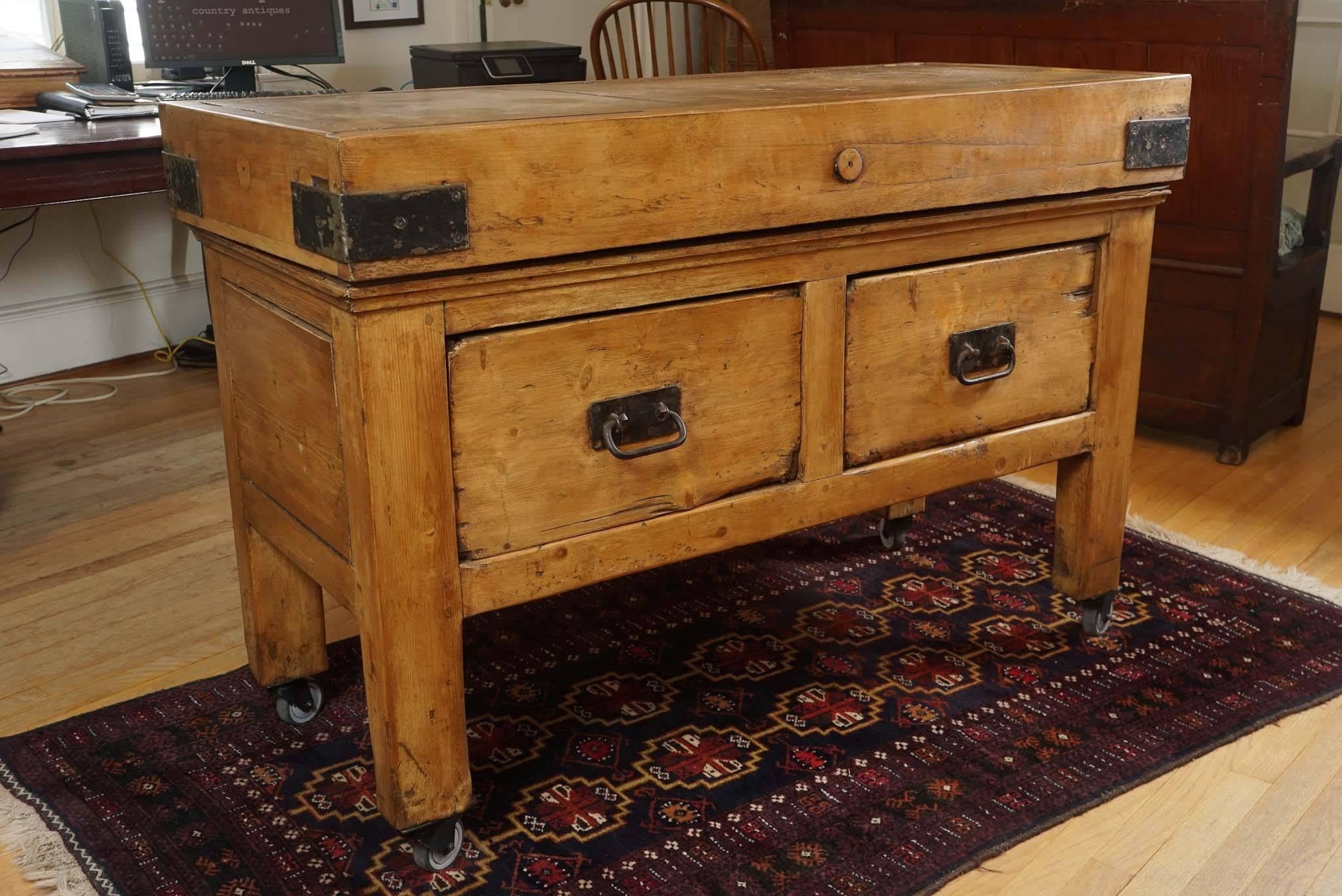 This butcher block is totally original, which means the base is also original to the piece. There are two large drawers that open from both sides and the hardware and brackets on the four ends of the piece are also original. I simply can't find a