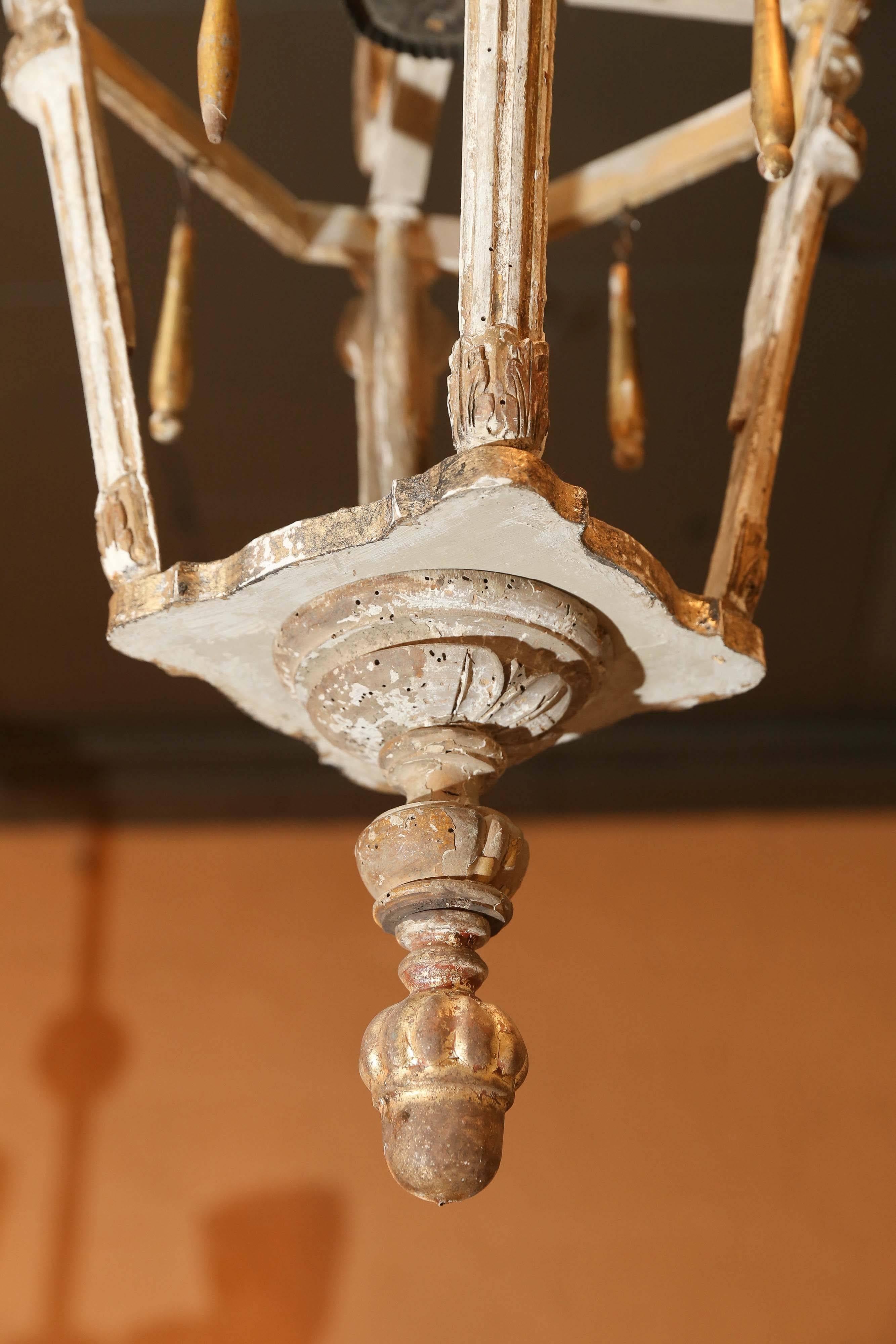Hand carved wooden French lantern made from antique fragments. Finial and bottom fragments in original gilt. Traces of gilt on the lantern. Can be wired for electricity at an additional cost.

Note: Original/early finish on antique and vintage metal