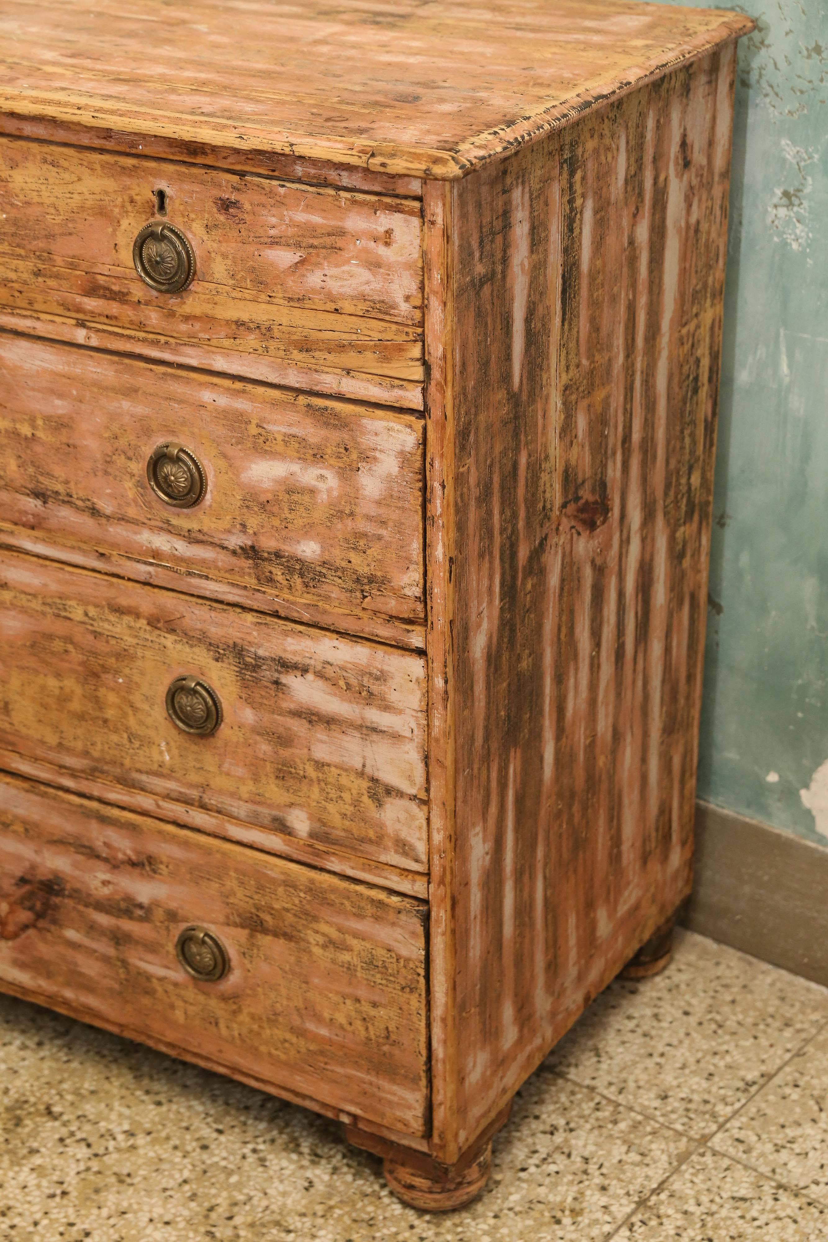 Painted and scraped pine commode in a salmon color with bronze hardware.