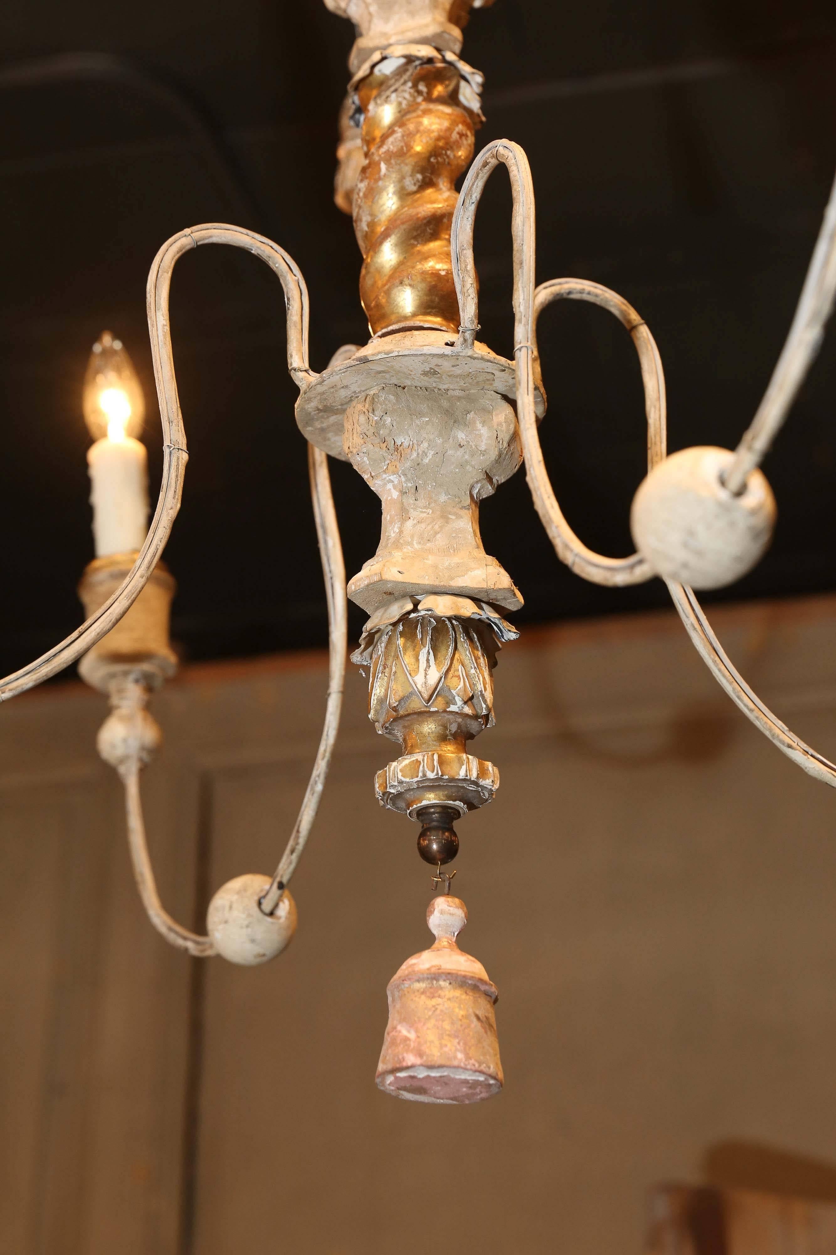 French chandeliers made from 18th and 19th century gilt and painted fragments. Newly wired for use within the USA with chain and a canopy.