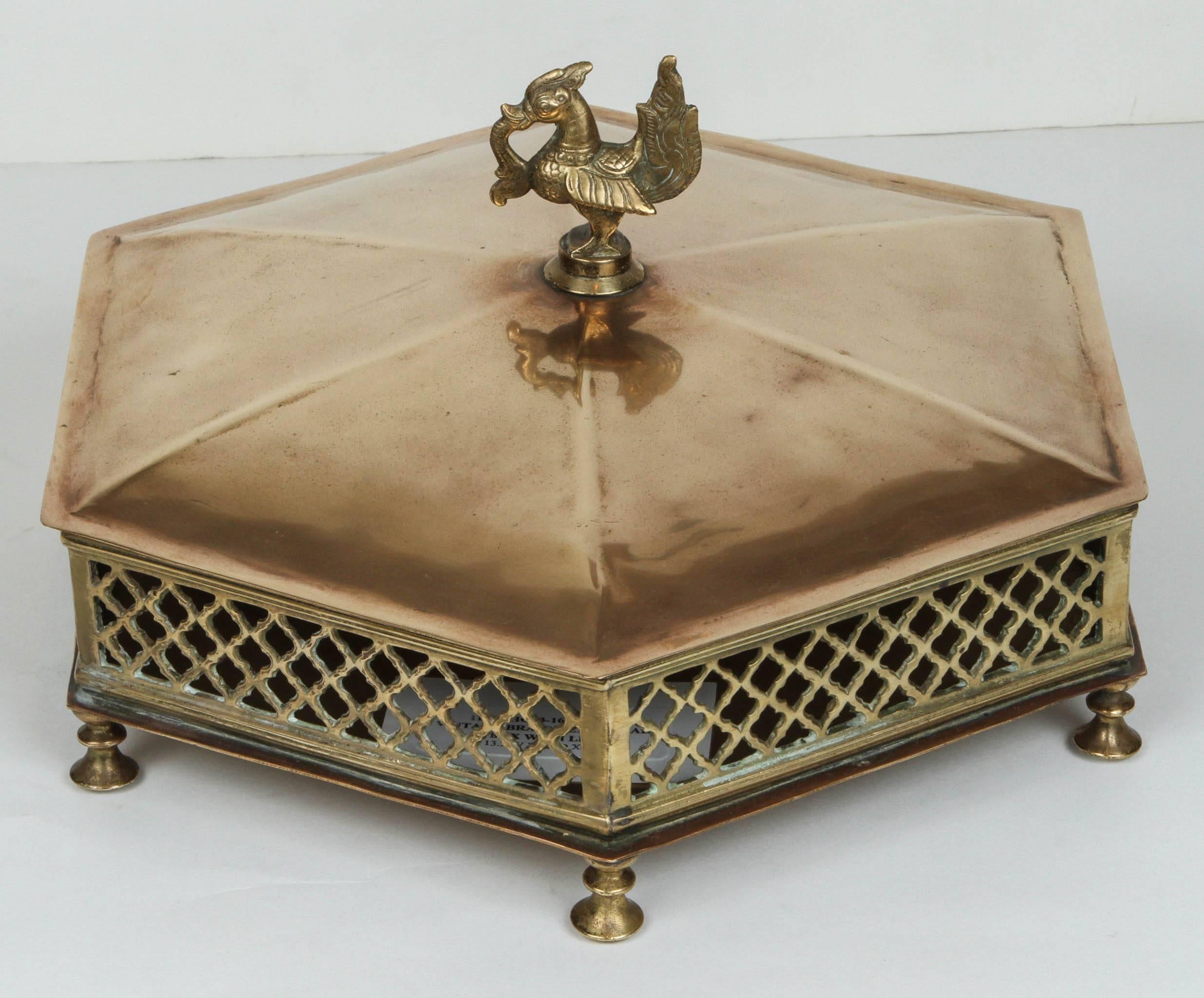 Beautifully proportioned eight six-sided brass box. Lattice sides, a domed lid, footed base and a bird finial all work together to make a stunning box that is beautiful and utilitarian.