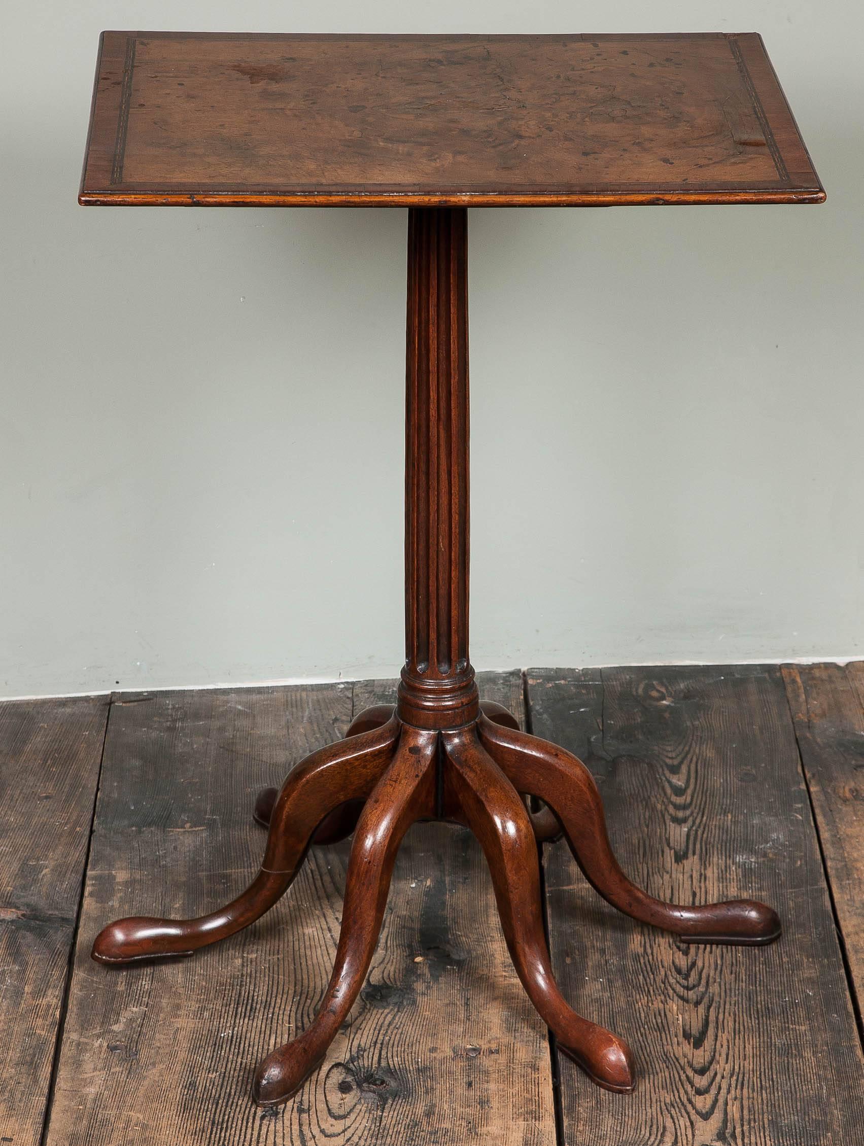 A highly unusual George III walnut and mahogany eight-legged tilt-top table.