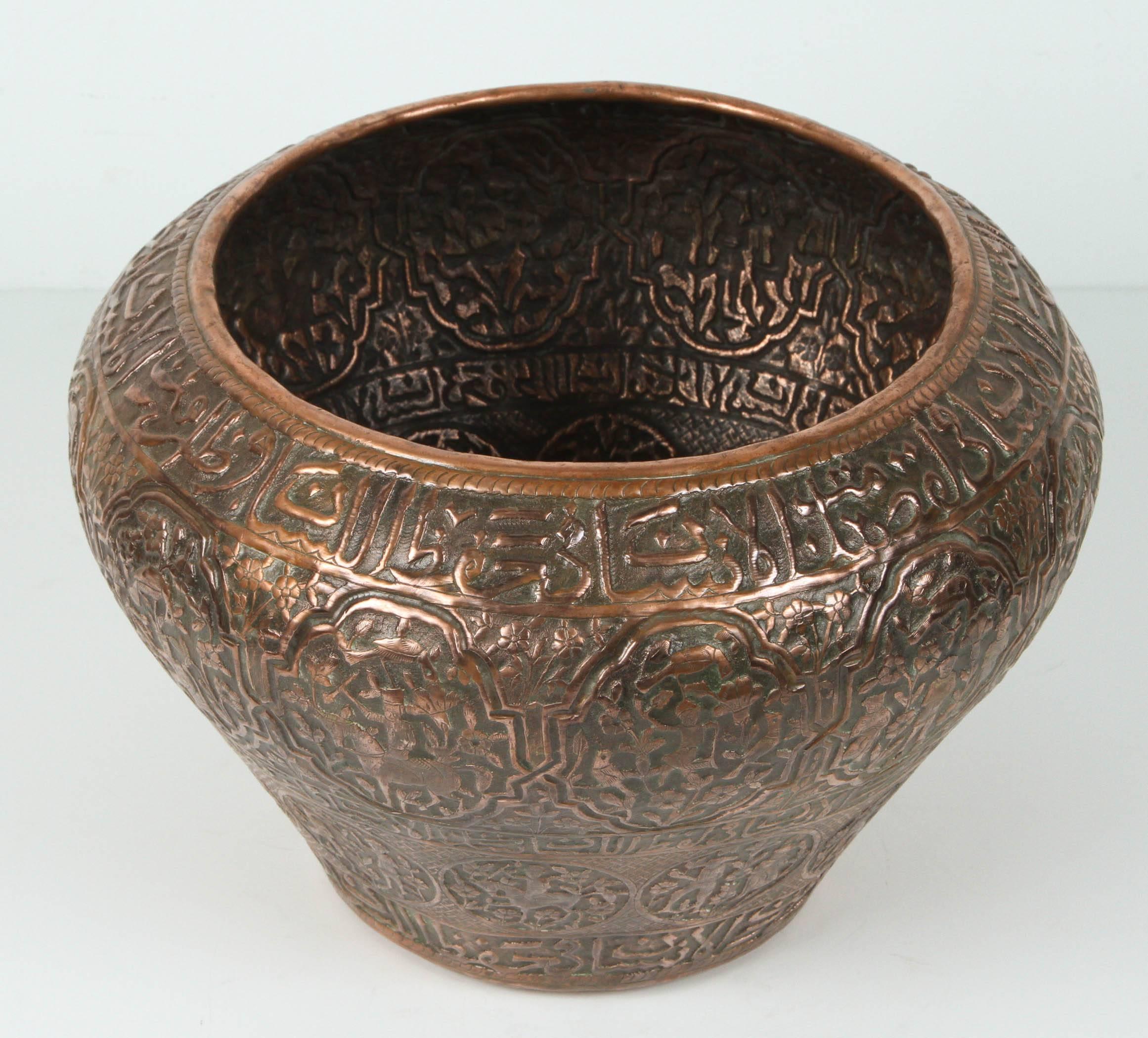 Late 18th-early 19th century large Persian copper urn, pot, hammered with Safavid script and scenes. 
Handcrafted Persian copper bowl with nice fine scenes designs.
Could be used as a jardinière or cache pot.
Engraved, incised and hammered with very