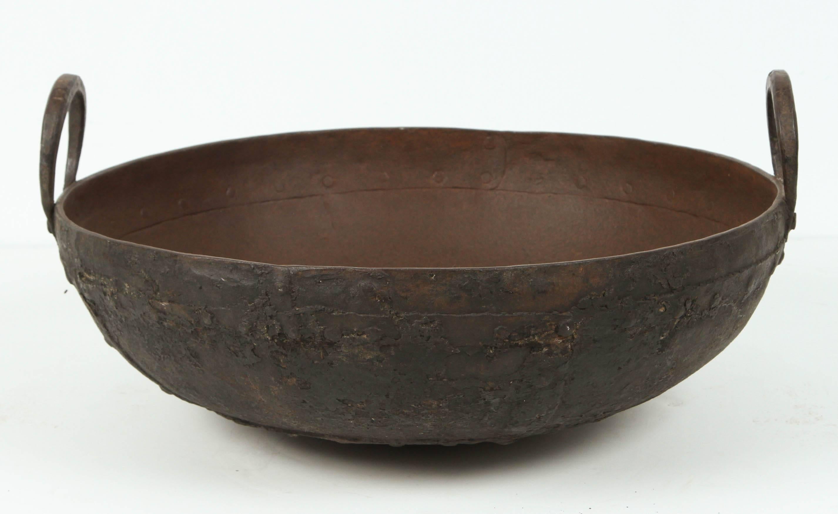 Large metal iron pots from Southern India known locally as an urli. 
These Pots were placed directly on a fire and large meals were prepared for special events.
They make great garden ponds, jardinieres, fire pits and other outdoor uses.
Hand-tooled