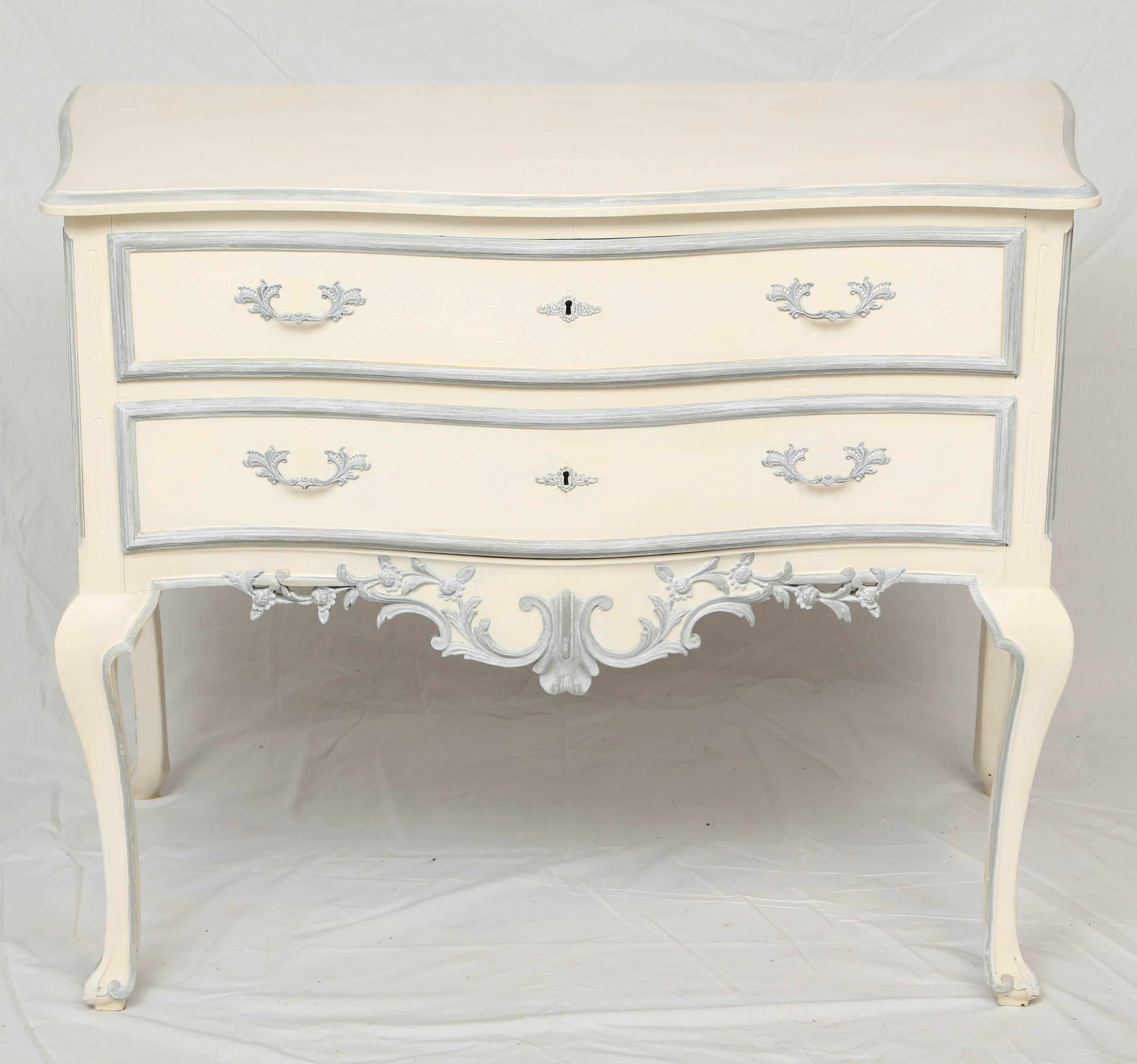 Pair of commodes, having a painted finish, each with a shaped, molded top, over conforming base, double stacked, raised and fielded drawers, serpentine apron decorated with foliate carving, raised on cabriole legs, ending in scroll toes.

Stock ID: