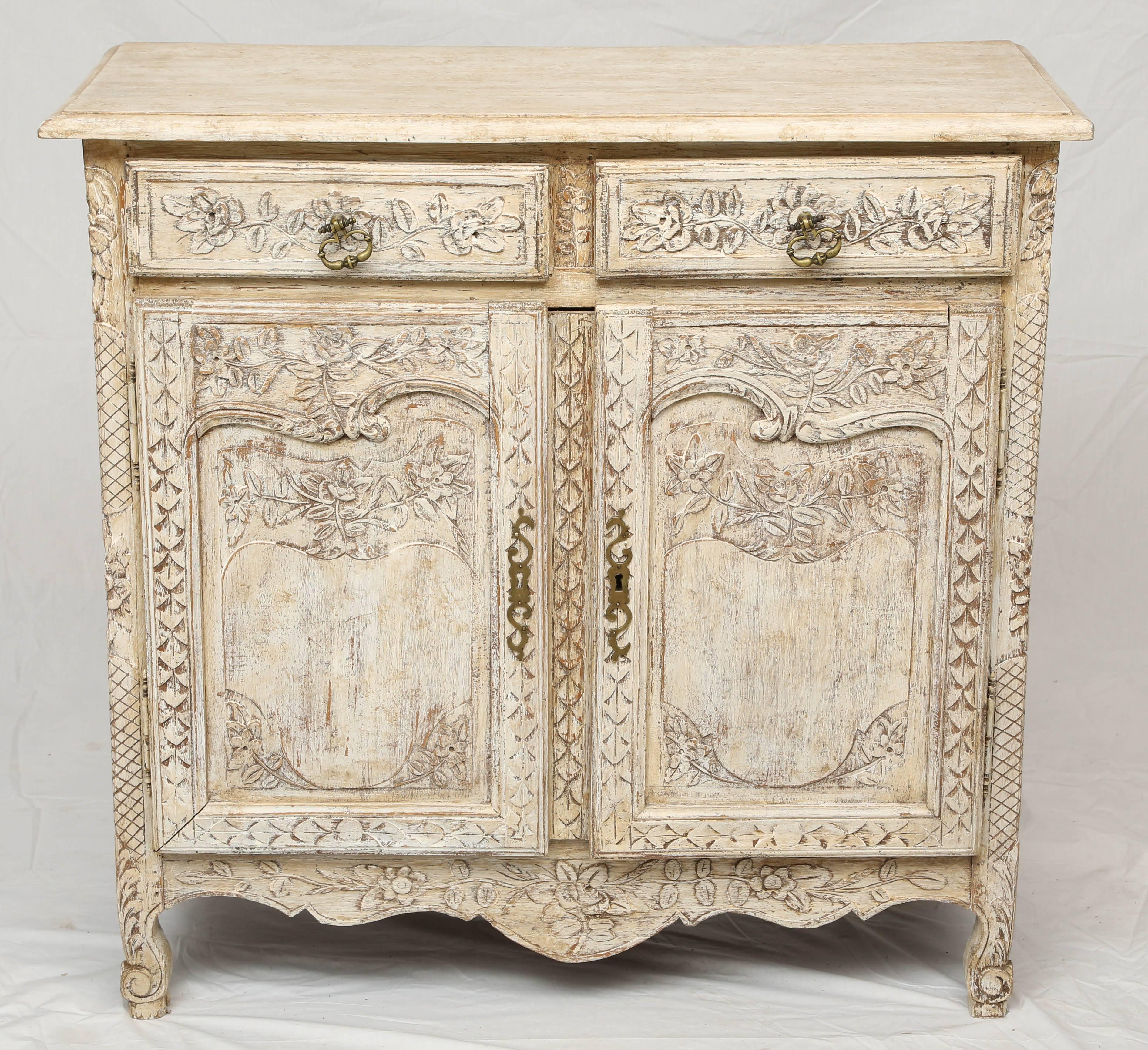 Enfilade, of oak, having a distressed painted finish, elaborately foliate carved case, its rectangular molded top, over double frieze drawers, with double cupboard doors, serpentine apron and raised on scrolling legs.

Stock ID: D9370