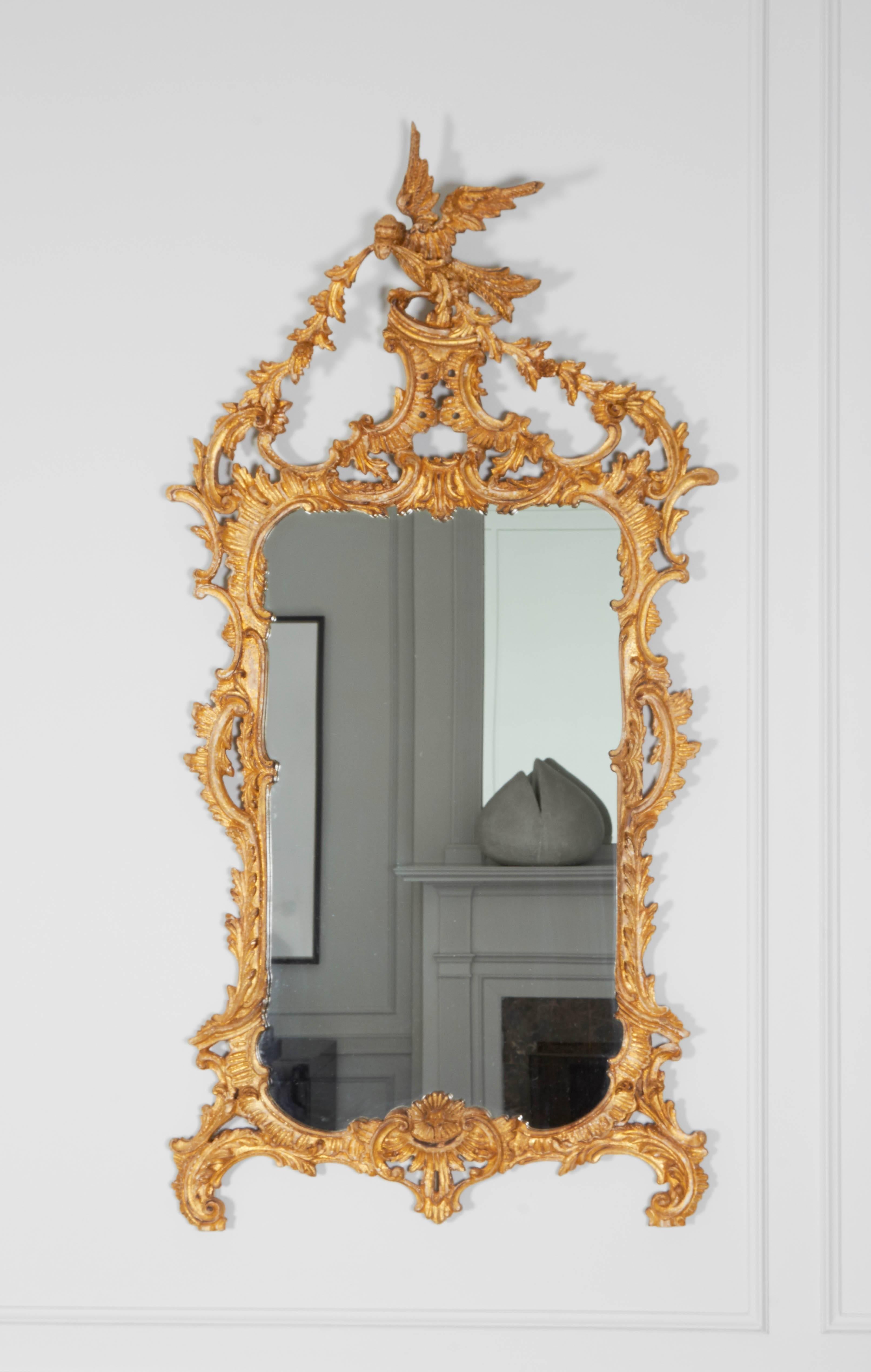 A stunning carved giltwood Rococo phoenix crested mirror.
 