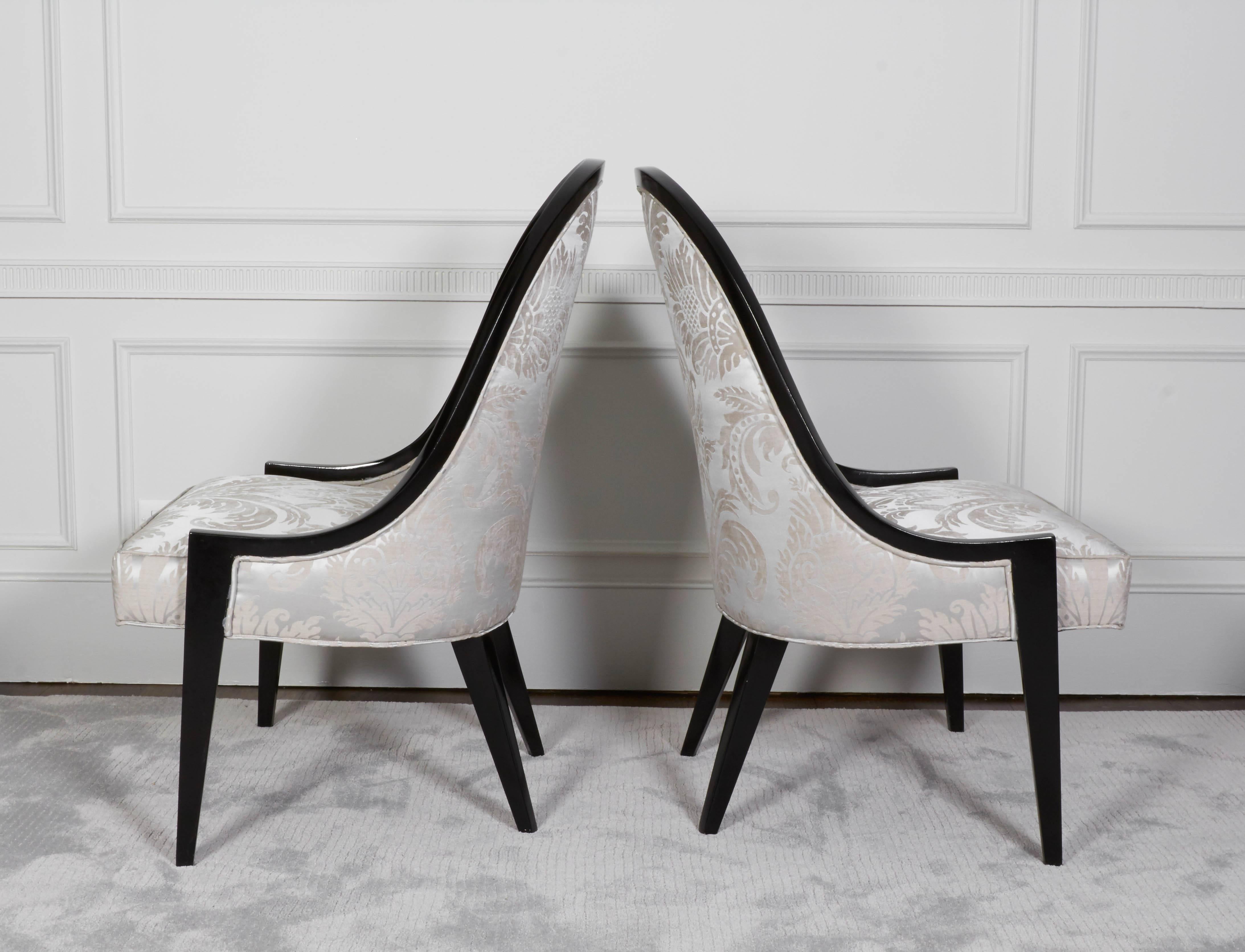 A pair of Classic gondola chairs by Harvey Probber with a newly black lacquered frame and Dedar silk Damask print.