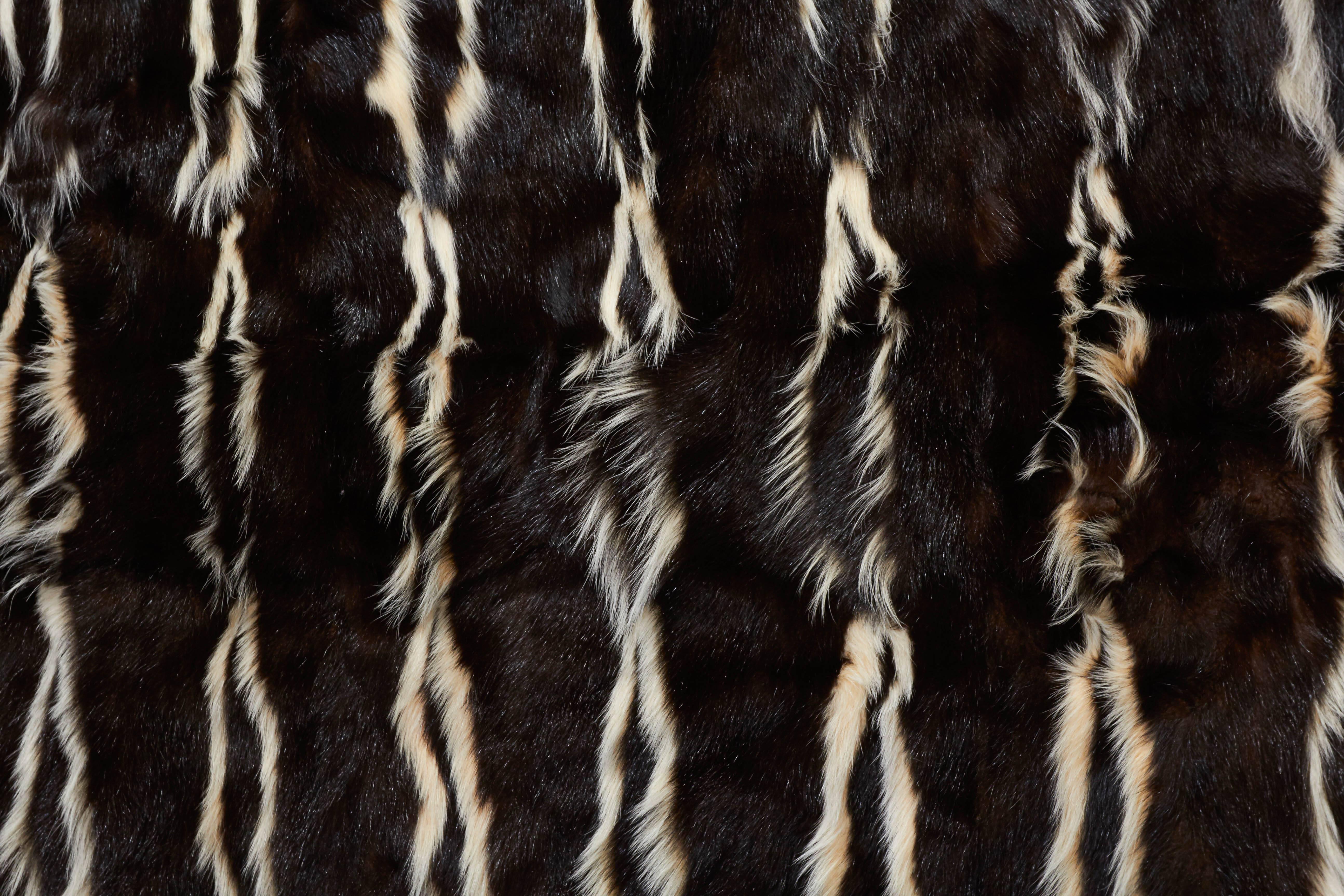 This striking authentic fur is made of skunk fur and can we used as an area rug or throw/blanket.