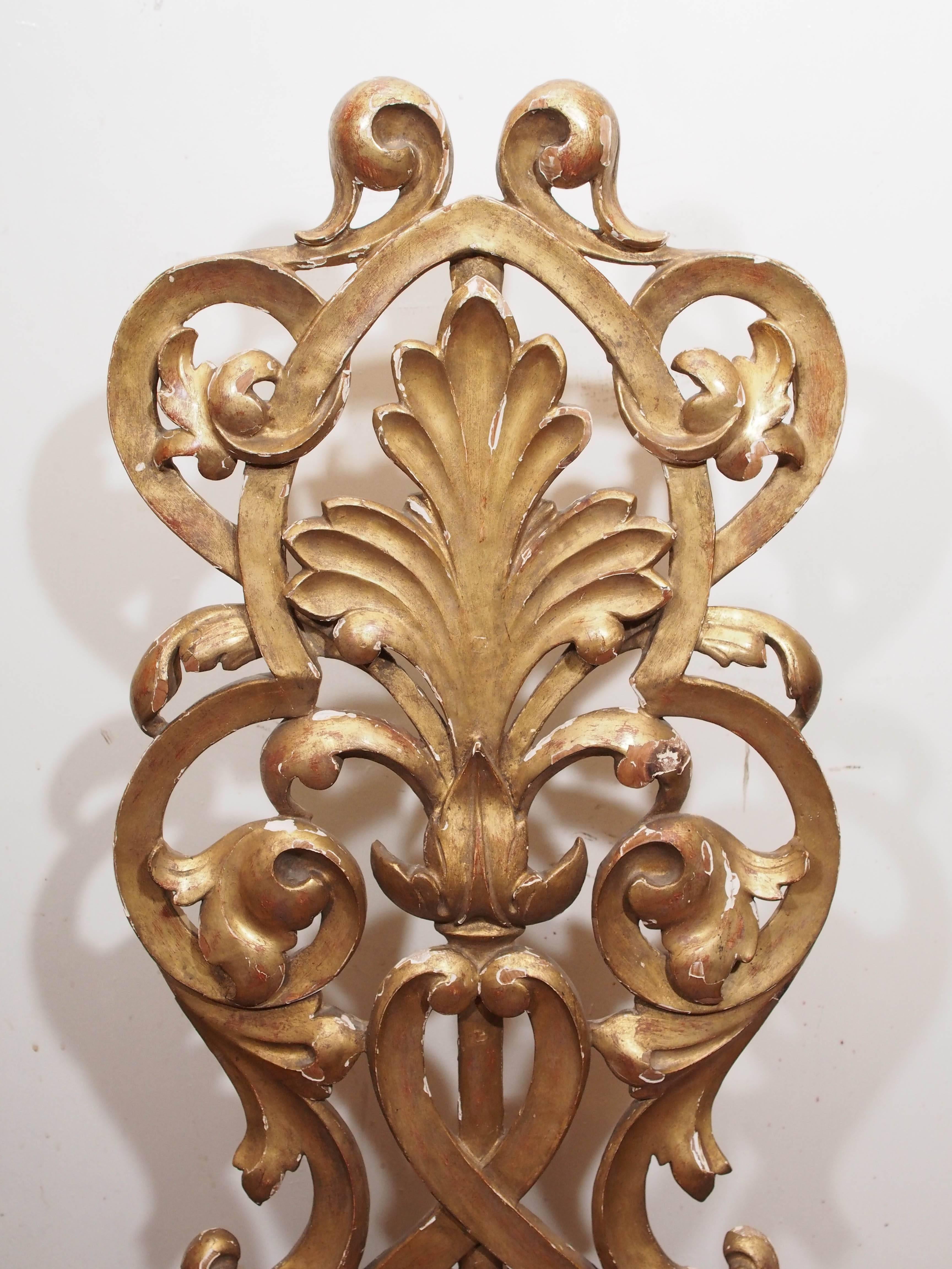 Pair of foliate carved giltwood elements of Italian origin.