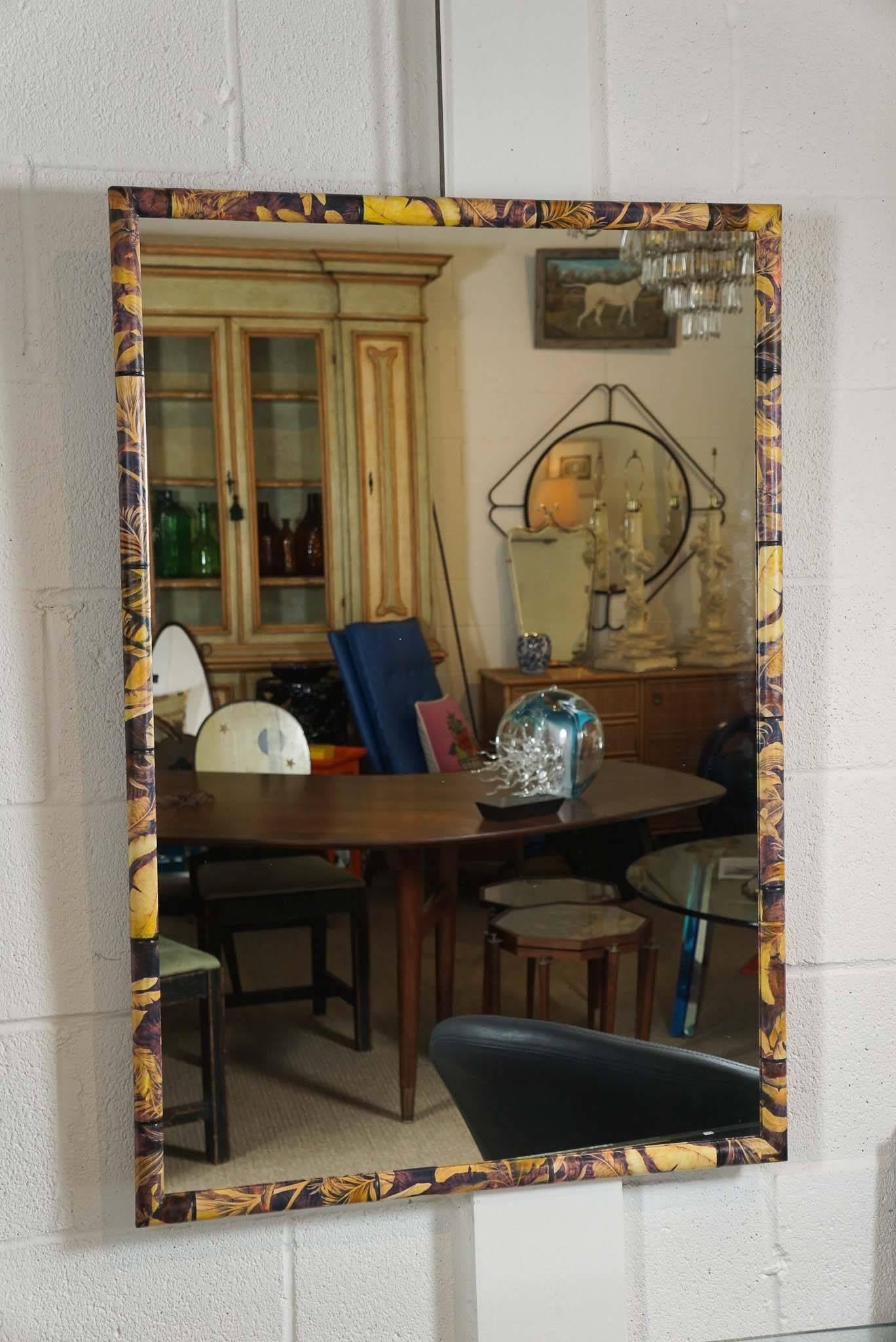 Here is a beautiful decoupage mirror in a banana leaf pattern with an incised bamboo motif. The narrow frame is wood and the surface is paper with a clear coat polyurethane finish.