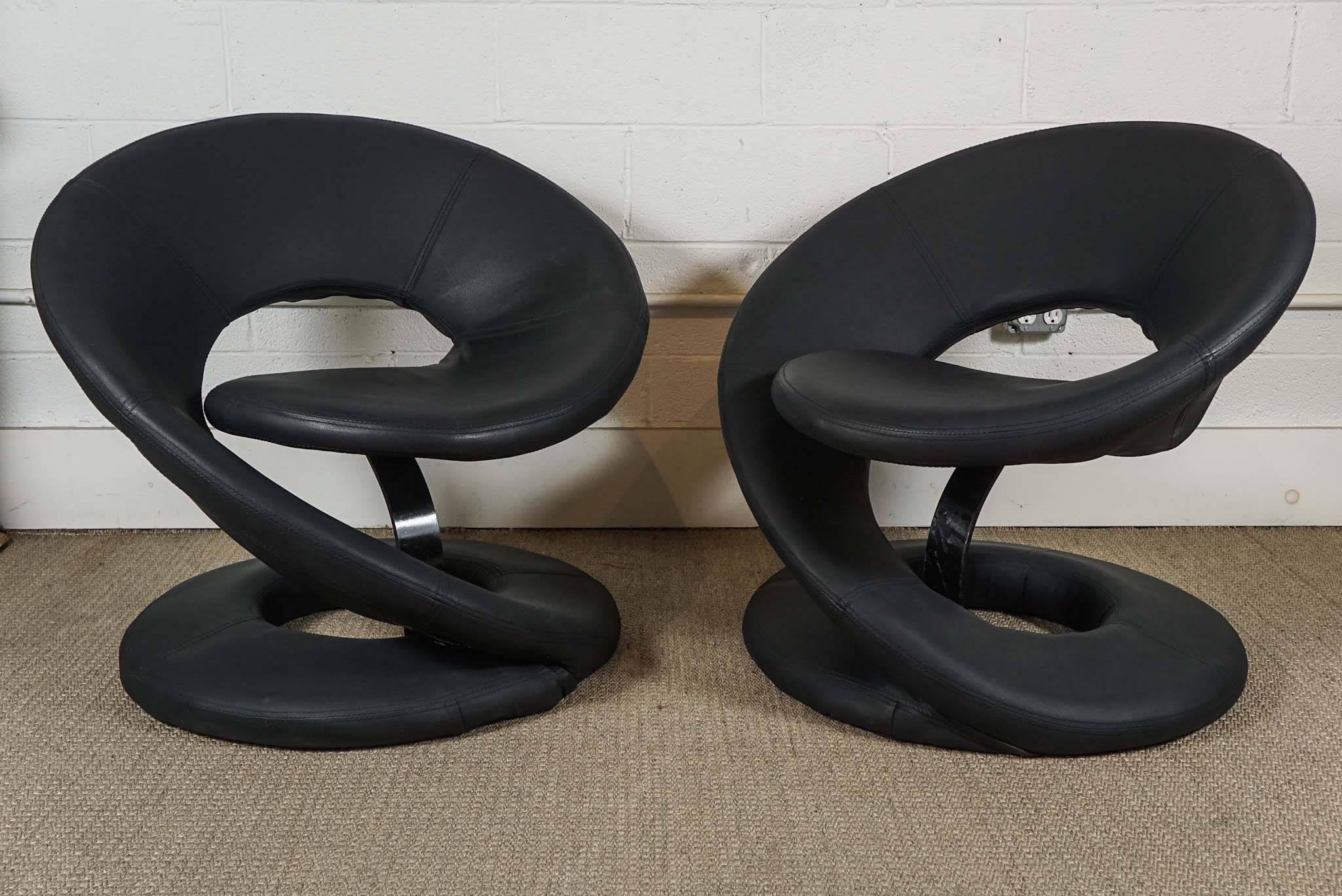 Here is a great pair of spiral lounge chairs in a black faux leather in the style of Louis Durot. The chairs are very comfortable as conversation chairs.