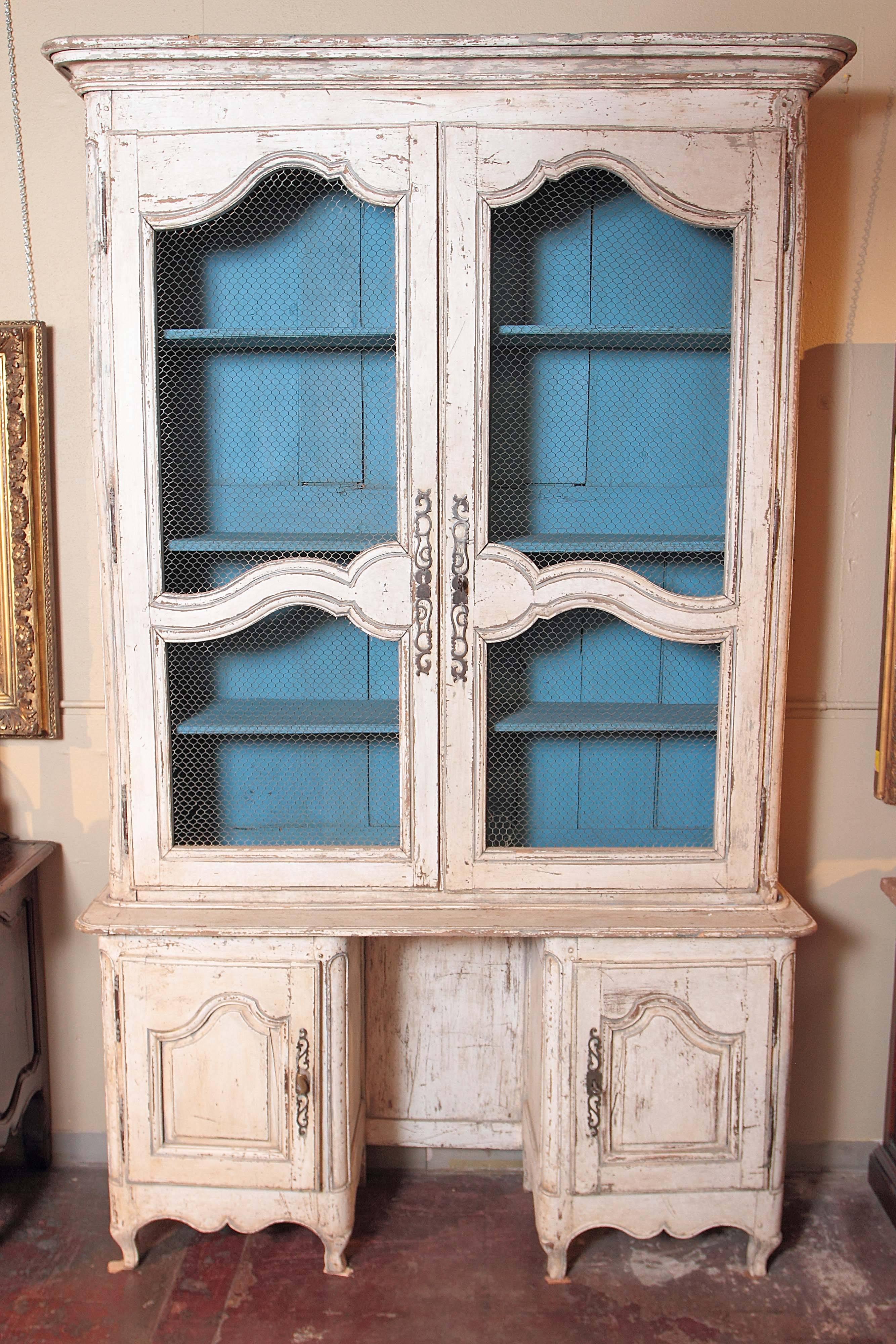Add more storage and display areas to your home with this elegant, antique painted buffet vitrine. This display cabinet from Southern France, circa 1760, features two large doors on the upper part with adjustable shelving and chicken wire netting
