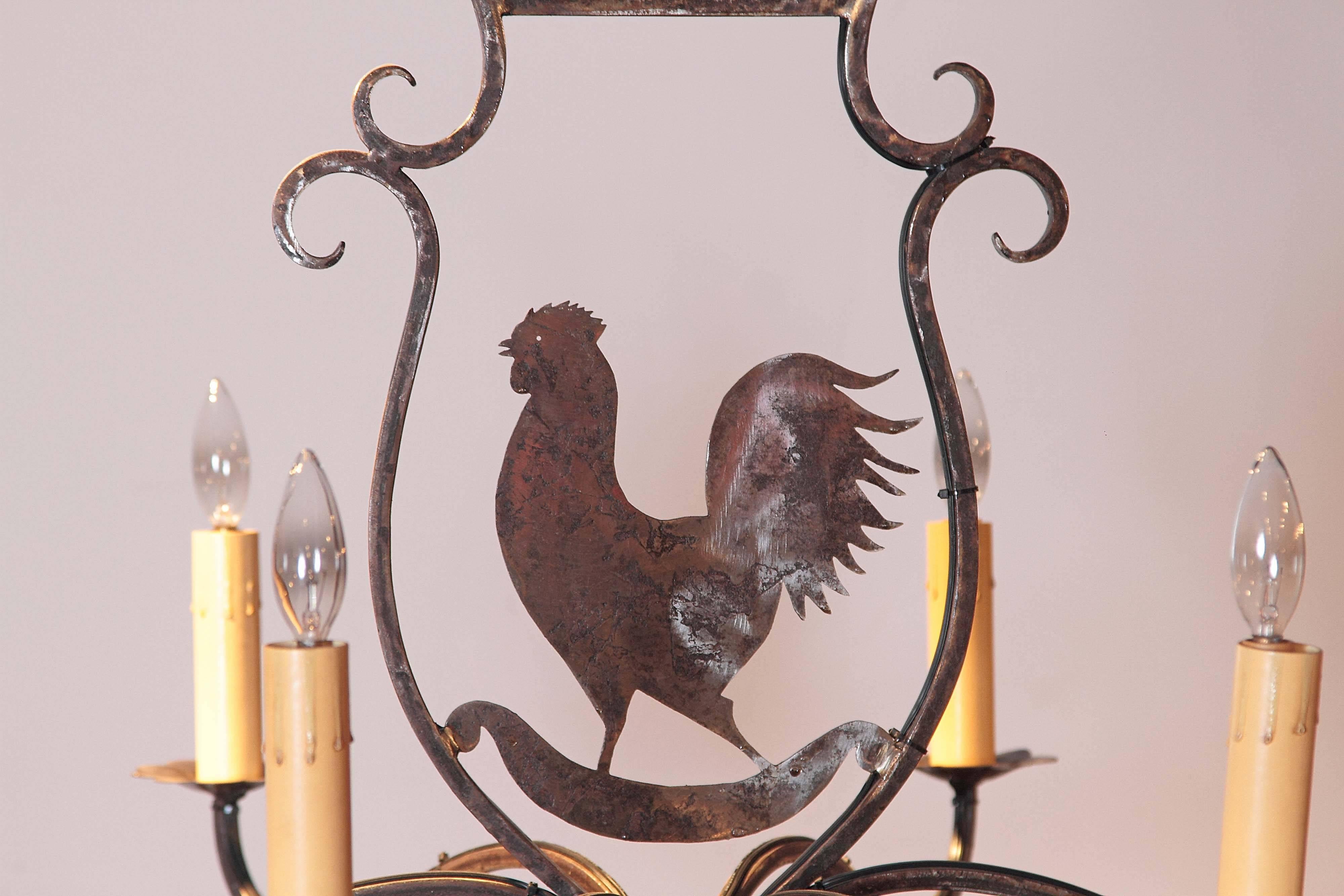 Elegant iron chandelier from France with six-light and a chanticleer in the center (on of the symbol of France). The fixture has a polished finish and has been rewired. Excellent condition. Ready to be hang in the breakfast room or over the kitchen