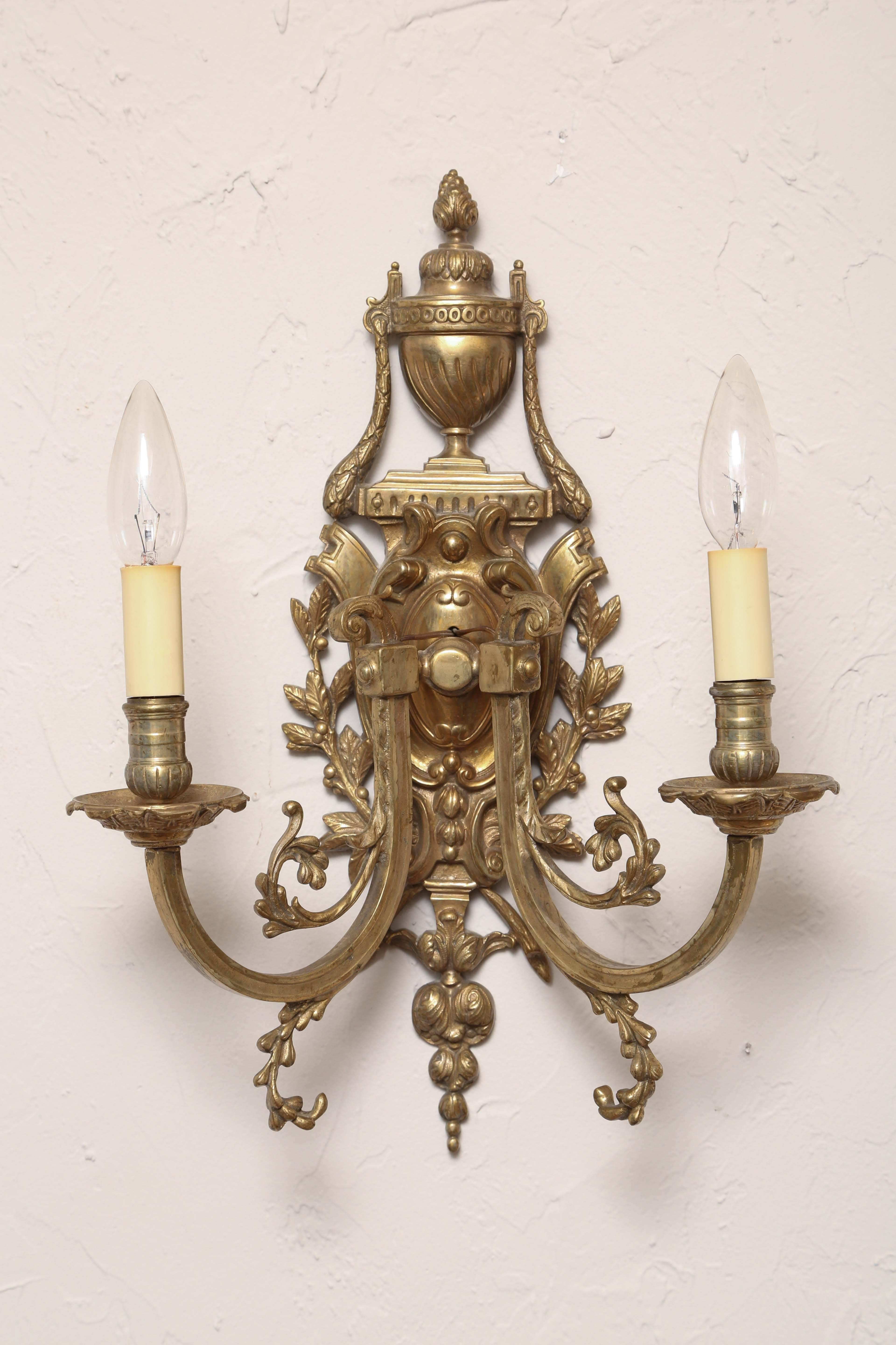 Lovely pair of antique neoclassical bronze two-arm sconces.