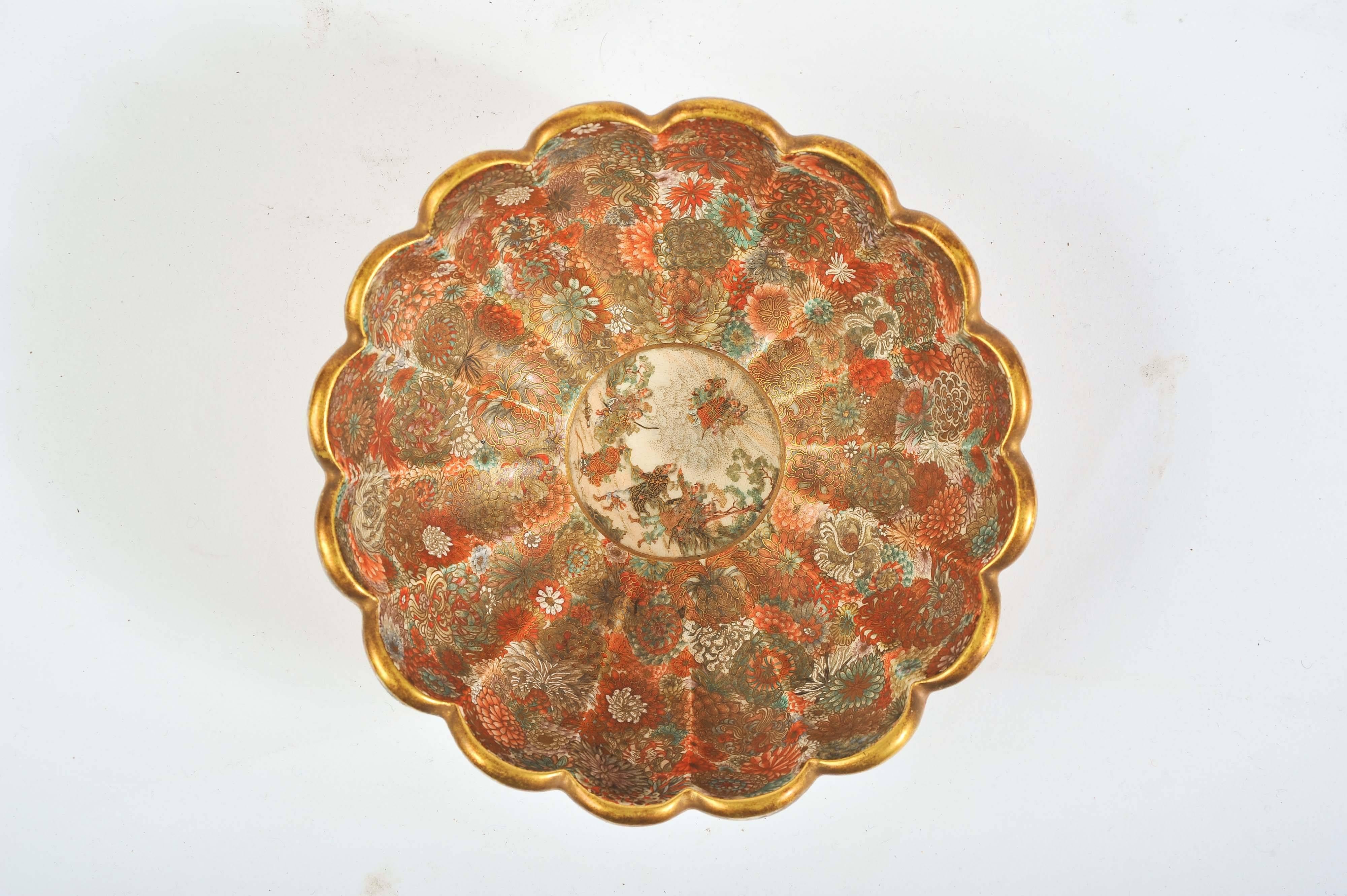 A fine quality 19th century Japanese Meiji period (1868-1912) Satsuma scalloped shape bowl. Having wonderful bold flower decoration inside and out and a classical Japanese scene to the centre depicting warriors looking up to the Gods.