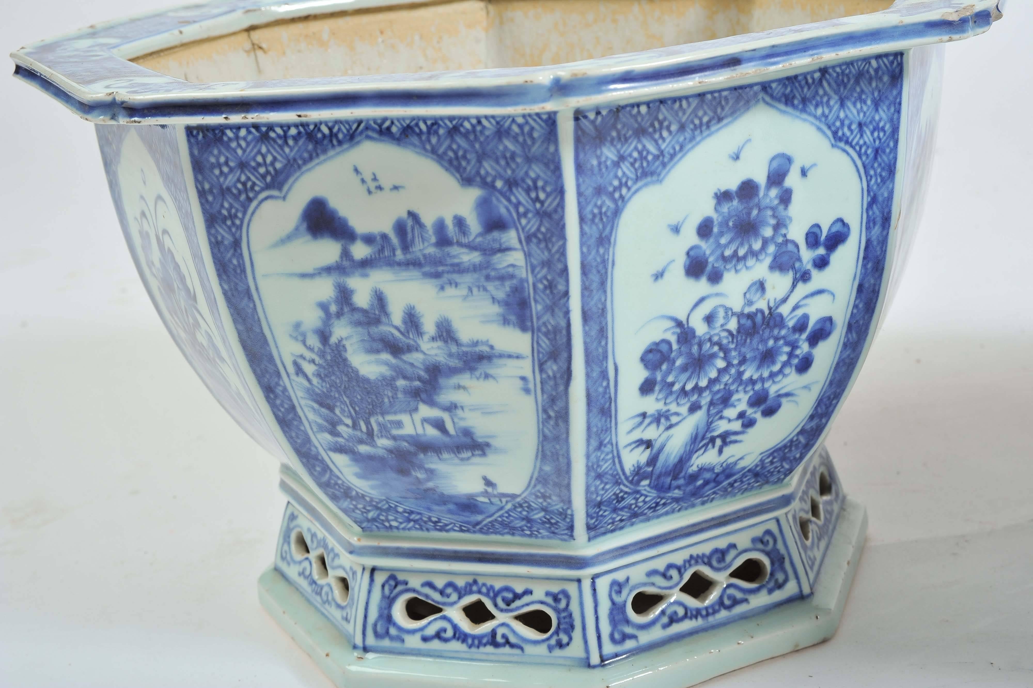 A good quality pair of Chinese 19th century blue and white jardinieres, each of octagonal form, each side having panels depicting classical Chinese scenes of flowers, lake and mountain scenes and raised on fretted plinths.