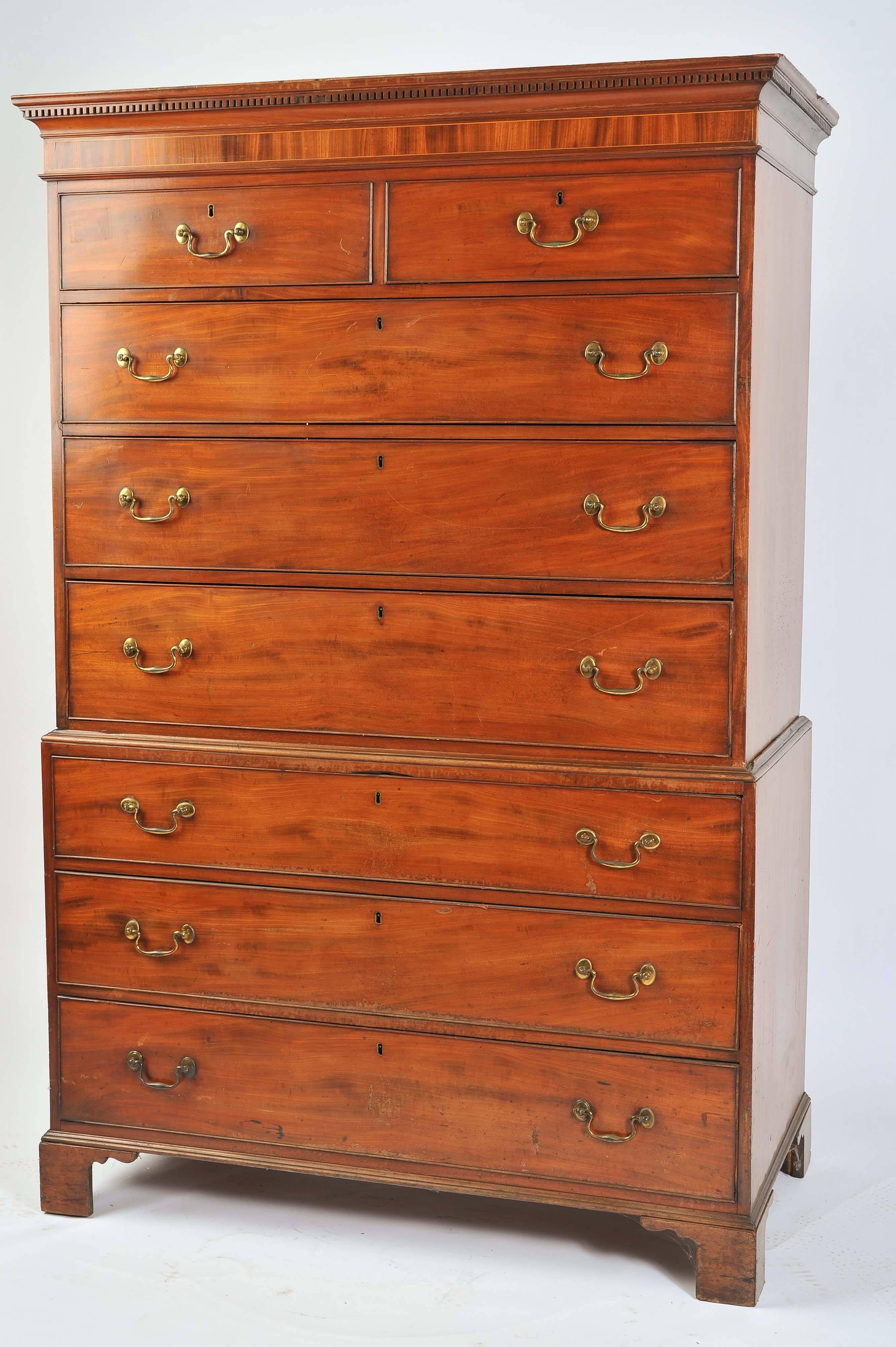 A good quality George IV mahogany chest on chest, having a dental cornice, two small and six long drawers, each with the original gilded swan neck handles and raised on bracket feet.