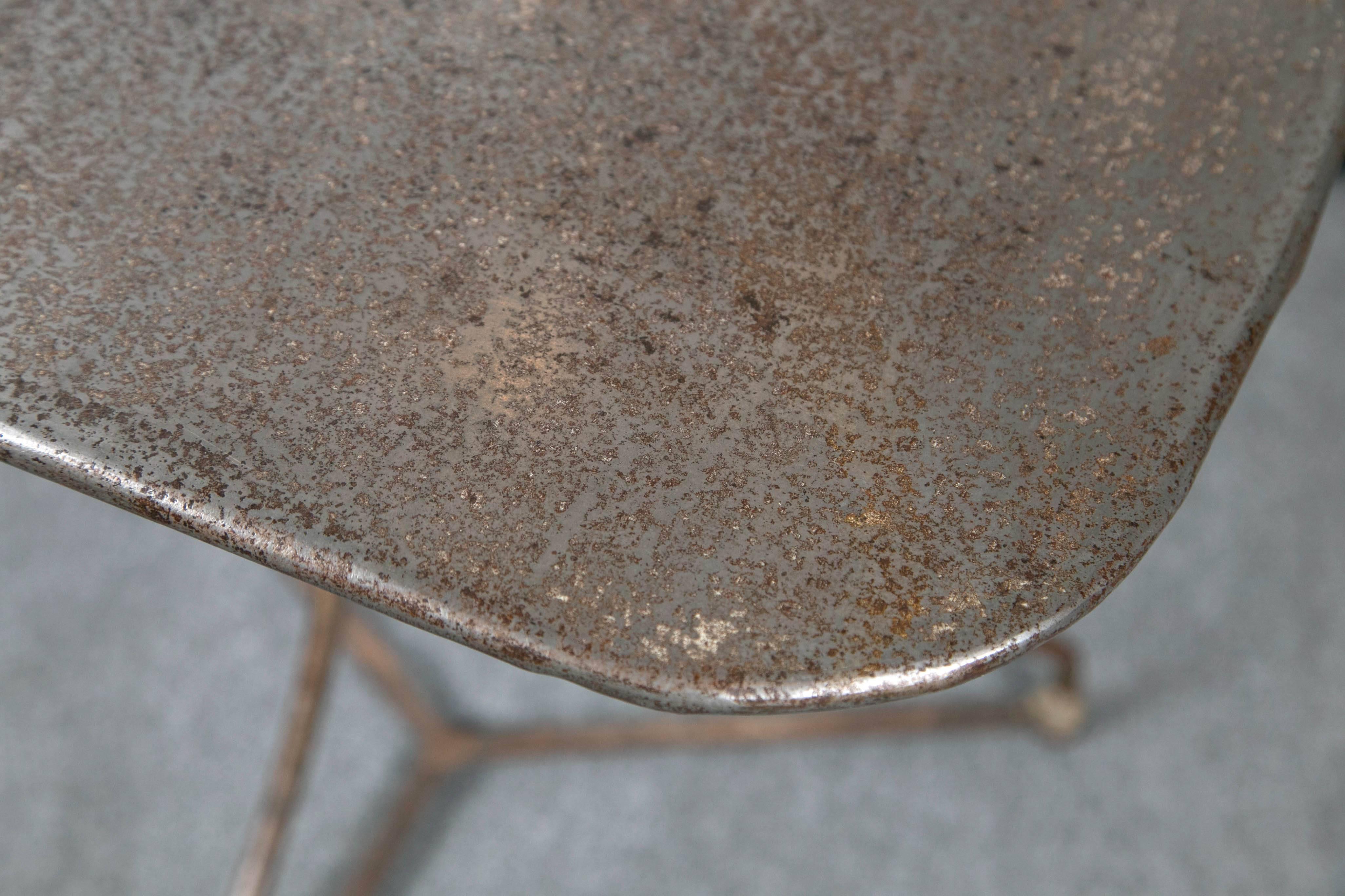 Bistro table, circa 1920, France. Iron base with zinc top. Rare shaped top. Wonderful aged patina.