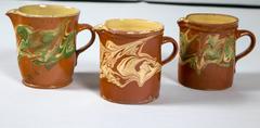 Collection of Three 'Jaspe' Pottery Pitchers, France, Late 19th Century
