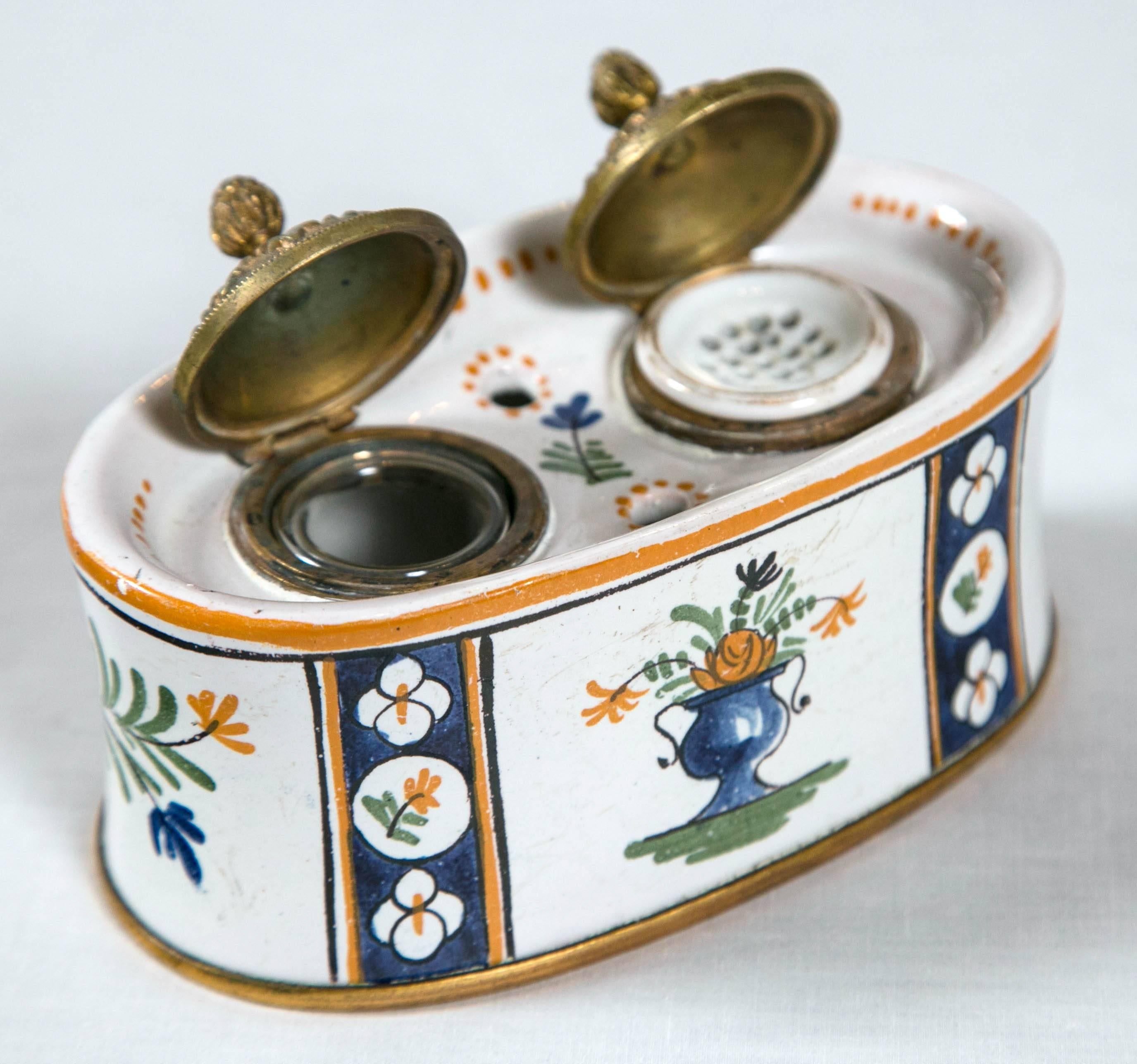 Traditionally hand-painted porcelain Faience Inkwell, France, late 19th century. Bronze lids and trim detail at base.