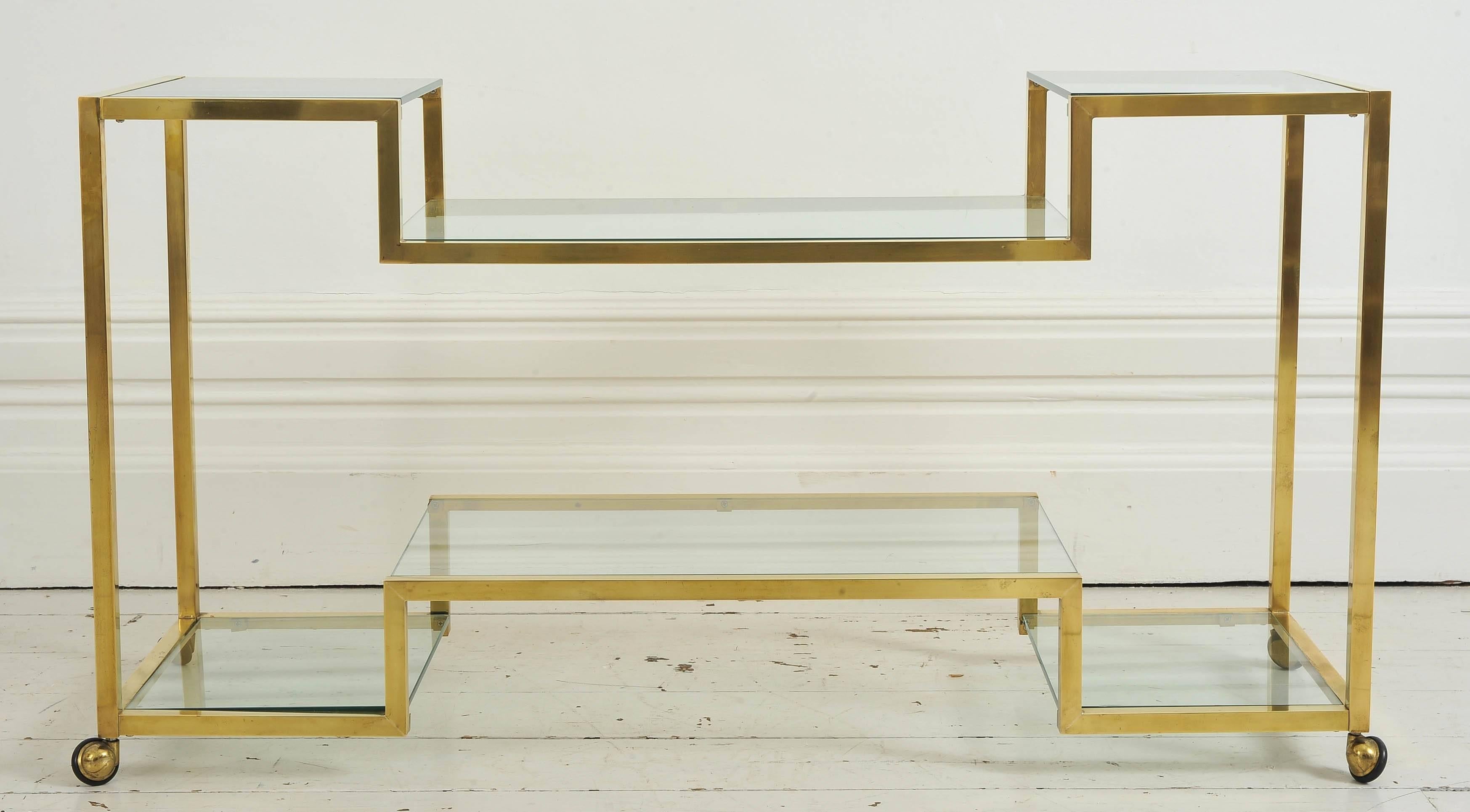 This lovely brass console has wheels and removable glass shelves.

Shipping: We are happy to ship this item to you for an additional cost. Please contact us for a quote.
