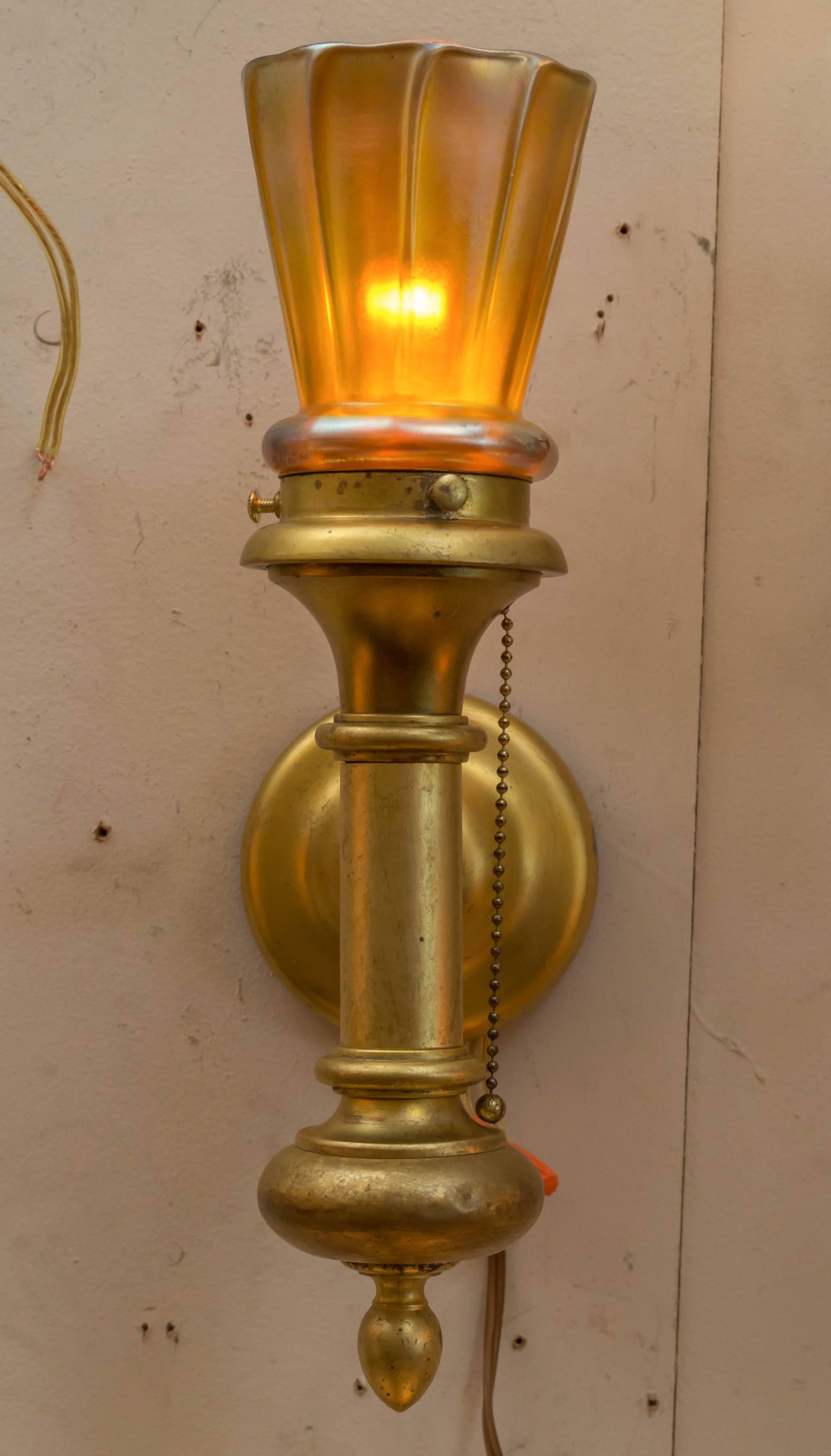 Simple yet elegant pair of sconces. Clean design on the metal work and handsome art glass shades, probably Steuben. Looking for sconces that point upward, here they are. A very nice package.