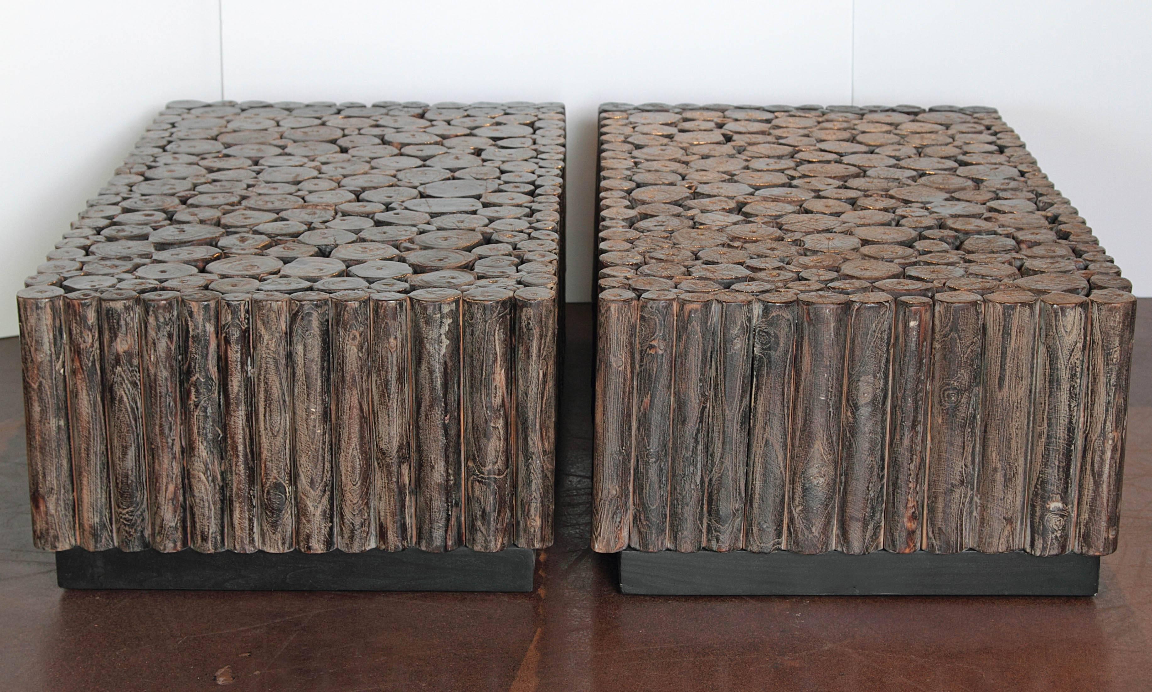 Organic Log Cocktail Tables 
 Teak logs that have been arranged next to each other to make a unique table on black plinth base.
Dark black / brown patina. 



