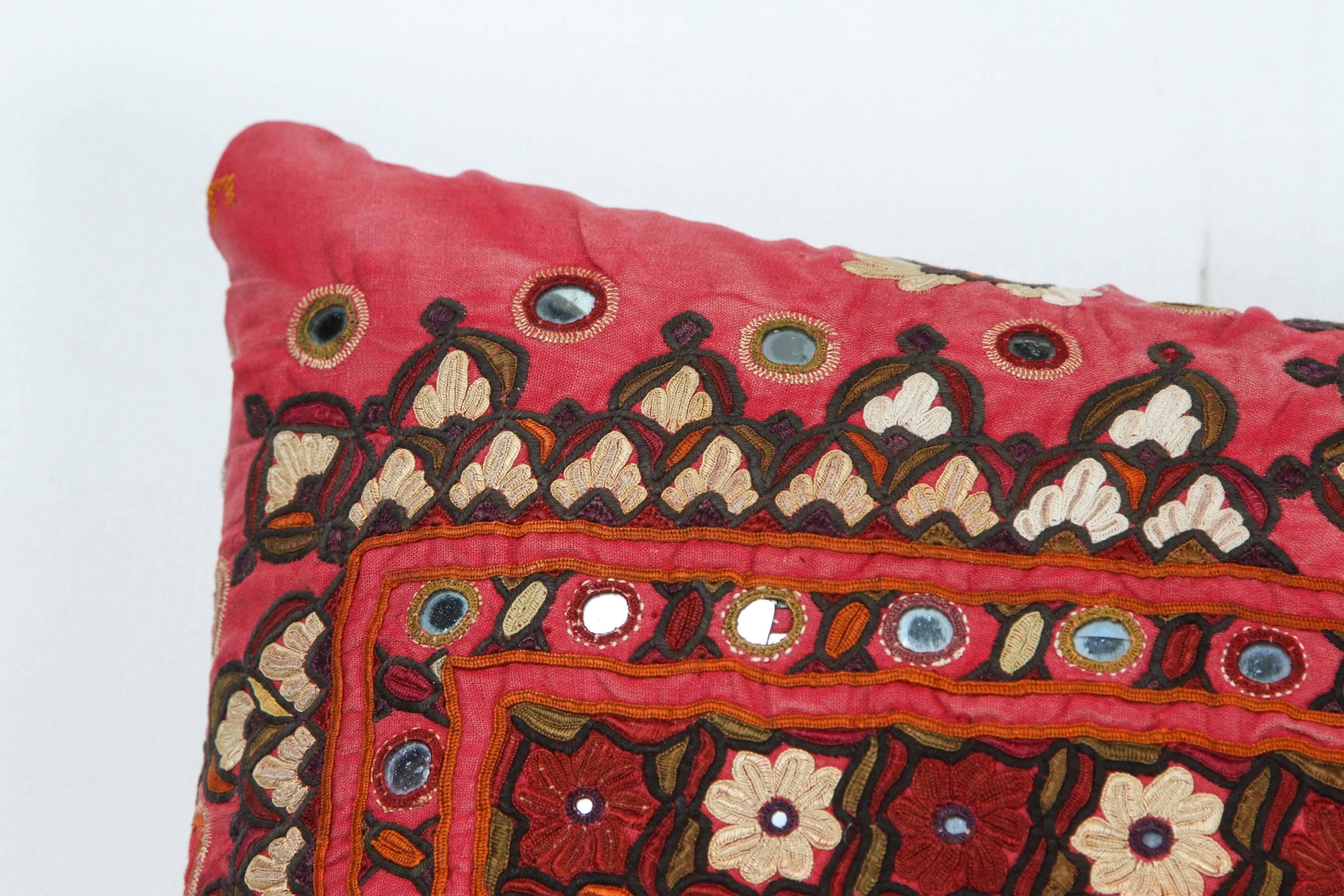 Shisha or Abhola Bharat work is embroidery work with small mirrors from NW India, usually Gujarat or Rajasthan. Red cotton with dark red, ivory, green and orange cotton embroidery. Natural linen back with feather and down fill and an invisible