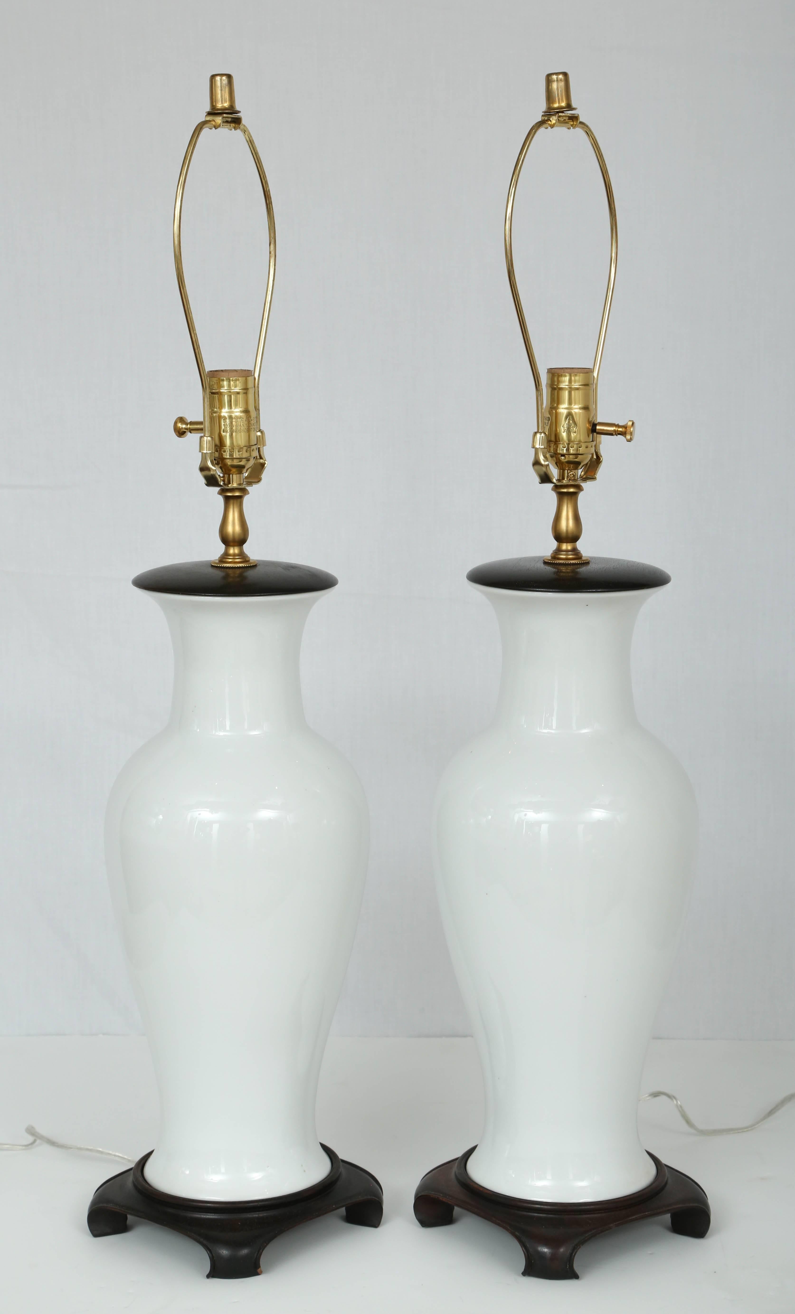 Pair of Blanc de Chine Vase-Form Table Lamps, Hong Kong, 1960s. This stylish pair of Blanc de Chine table lamps will work well in your cleaned lined modern or glamorous Hollywood Regency space.

Note: Height to top of socket is 23.50