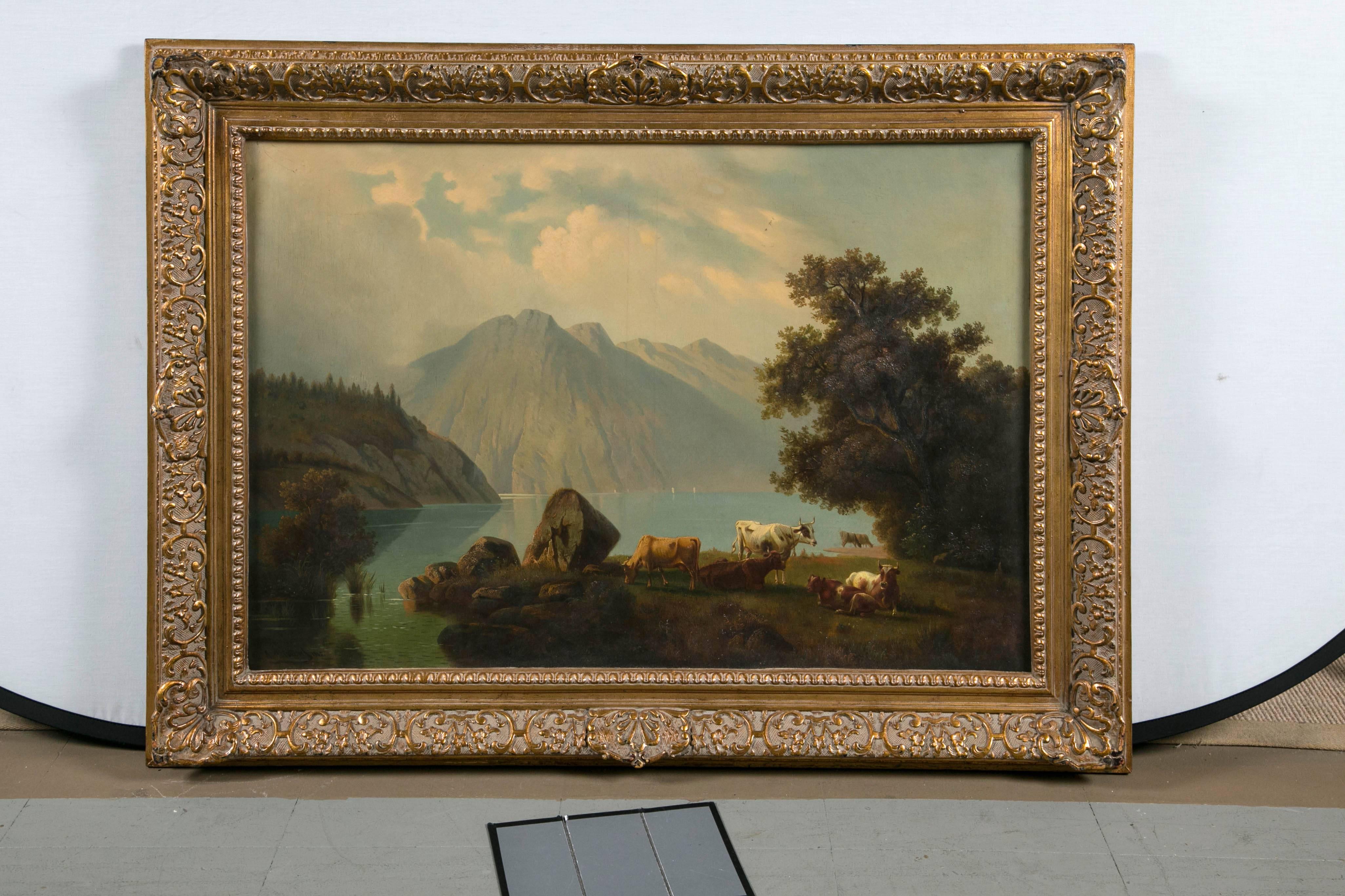 A very fine 19th century oil on canvas in extremely fine detail depicting a lush landscape with lifelike cows. Signed (illegible) in an antique gilded frame.