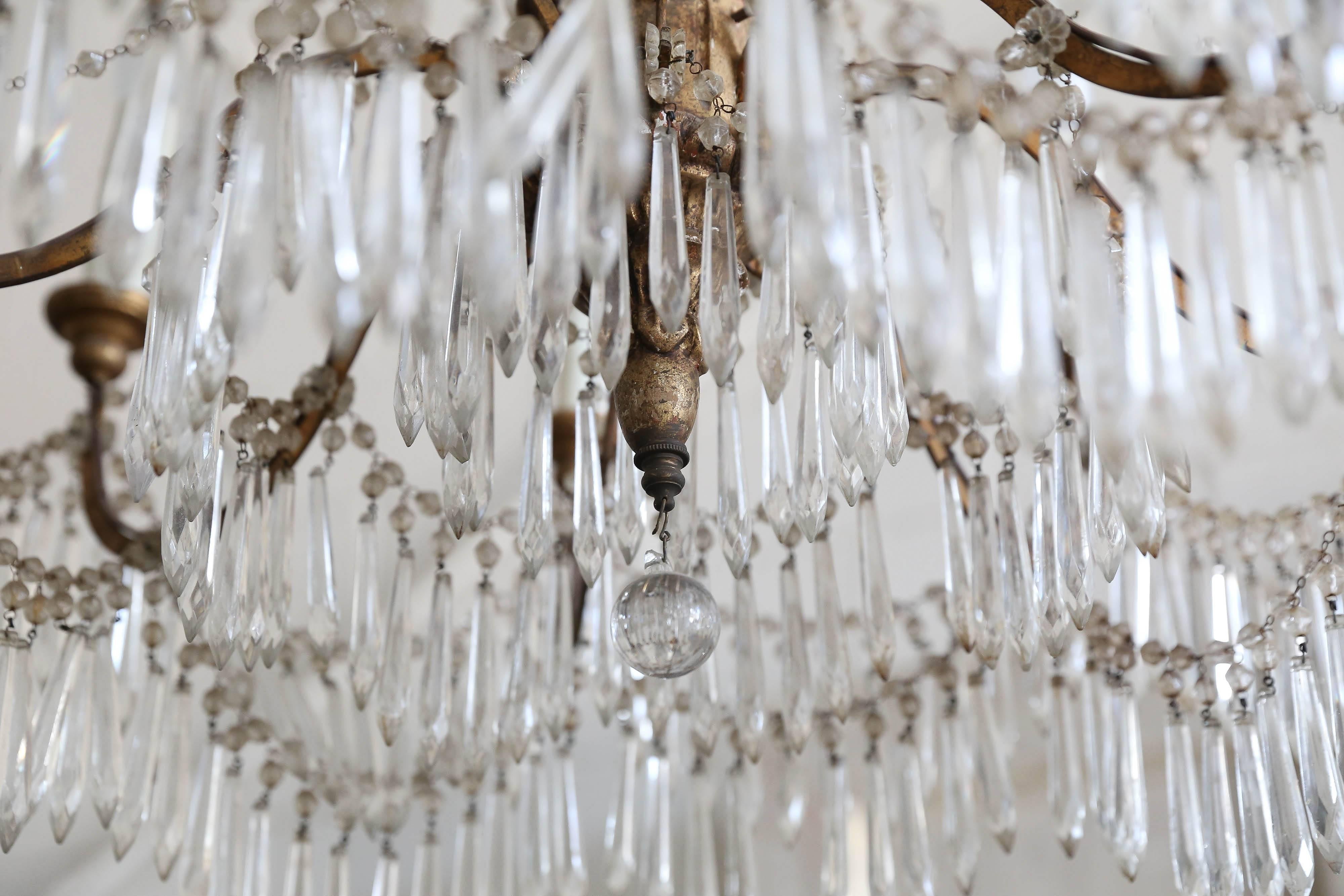 Italian wood carved and gilt, crystal chandelier with multi-tiers and eight arms. It has been newly wired for USA.