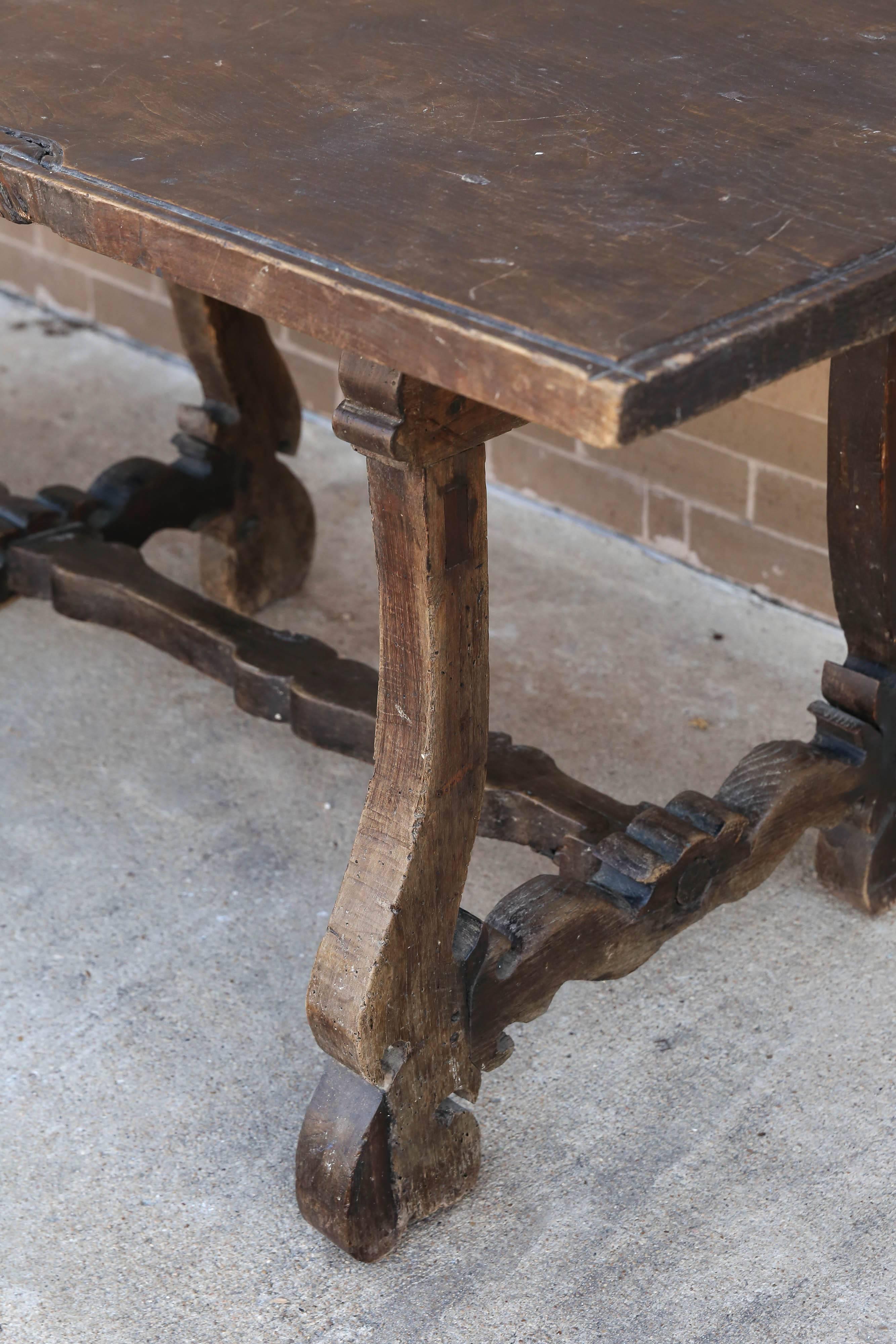 Carved walnut 18th century Spanish long console table that is perfect against a wall or floating.