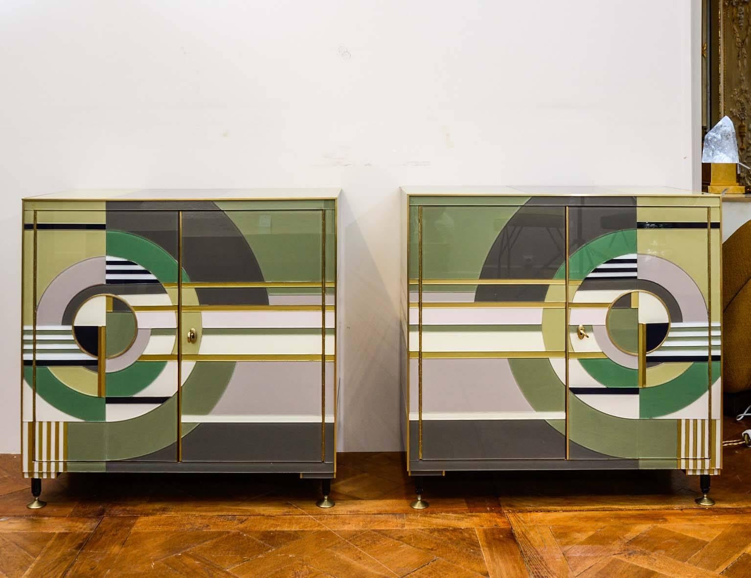 Pair of pieces of furniture in colored mirror with brass fillet, two doors and one shelf.