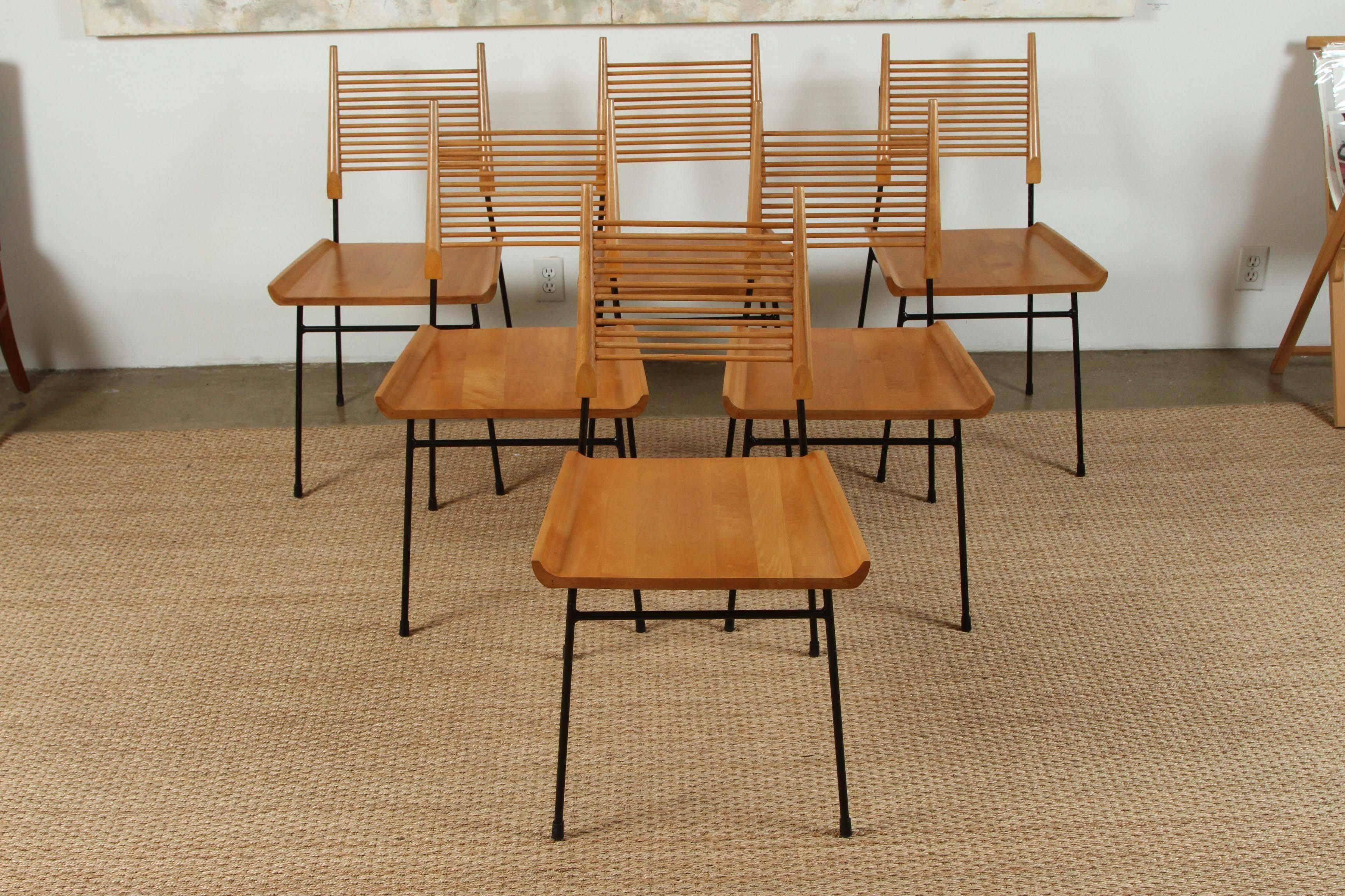 Paul McCobb maple and iron shovel chairs, circa 1950s in restored condition. Solid sculpted maple seat with turned spindle back supports on iron framework.

Paul McCobb (1917-1969) is an American designer best known for the Planner Group, his